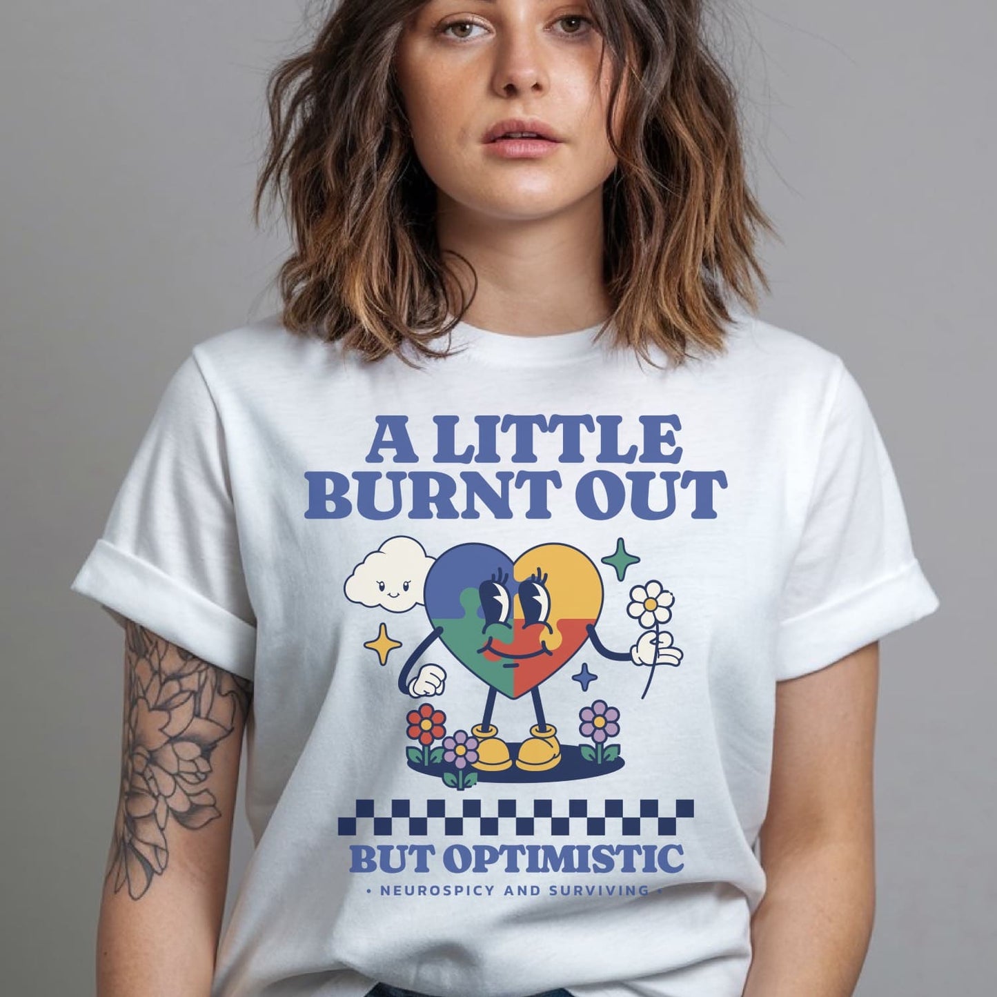 Person wearing a white t-shirt with colorful graphic and text: Retro Autism Shirt, Neurodivergent Affirming Tee, ADHD AuDHD Burnout TShirt, Motivational Shirt For Neurospicy, Positivity Gift For Autistic