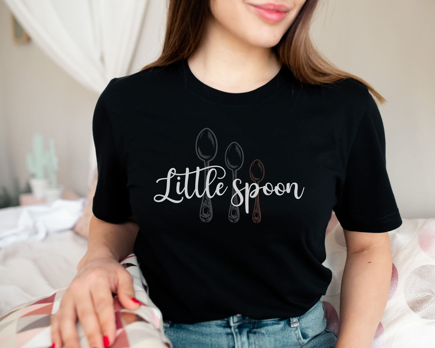 Polyamorous ENM person wearing a black t-shirt with 'Little spoon' design