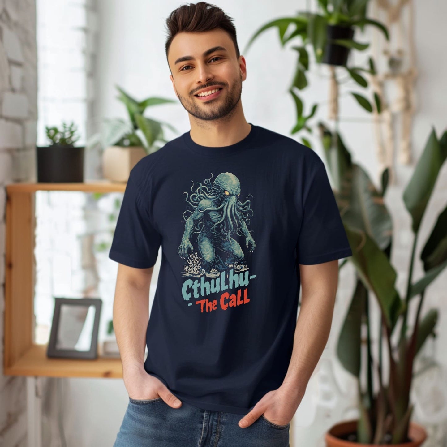 Man wearing a navy blue t-shirt with a graphic design of cthulhu