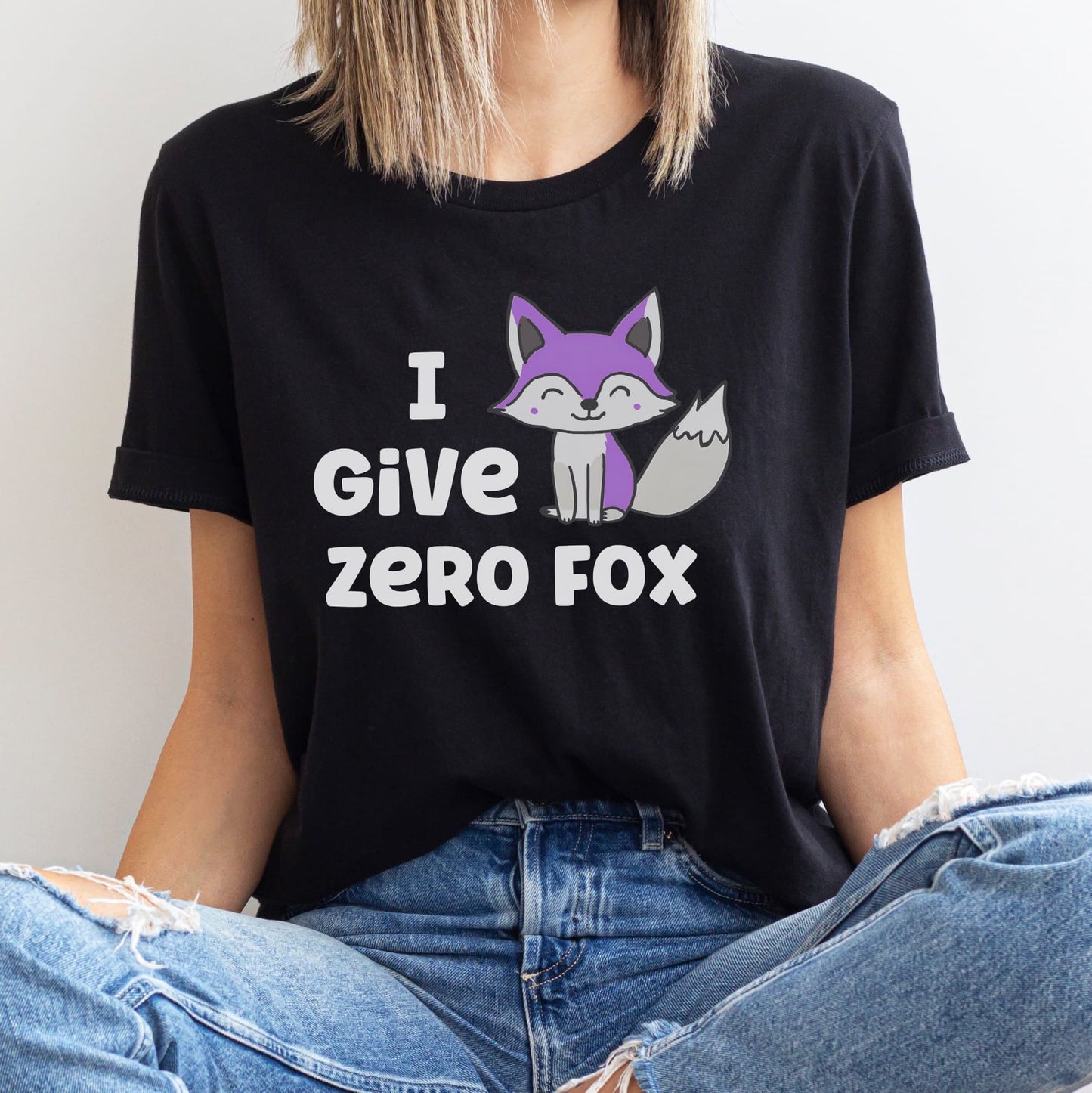 Asexual person wearing an ace pride funny black t-shirt with a fox graphic and text.