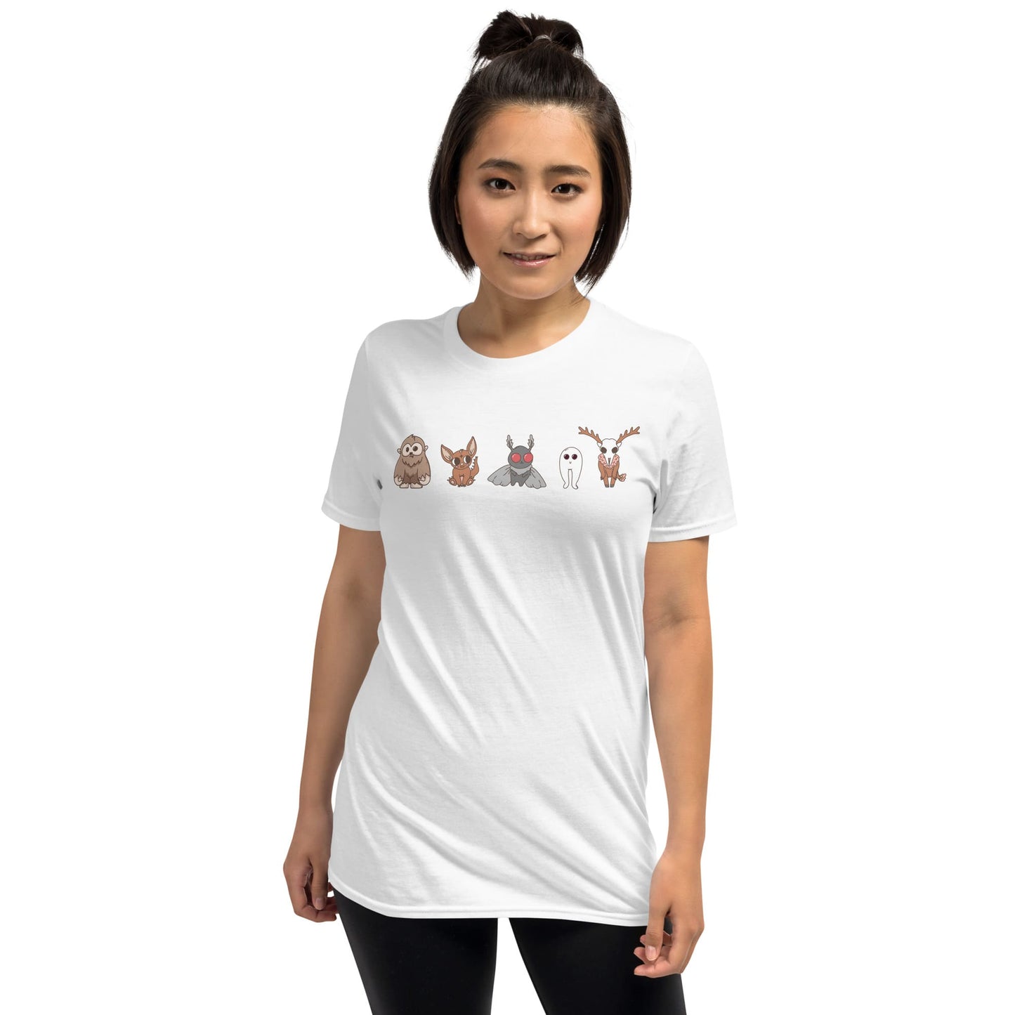 Woman wearing a white t-shirt with cartoon animal designs on a white background: Cute Cryptids Comfort Colors Shirt, Kawaii Bigfoot Chupacabra Mothman Fresno Wendigo Tee, Funny Cryptidcore Gift, Folklore Mythology T-Shirt