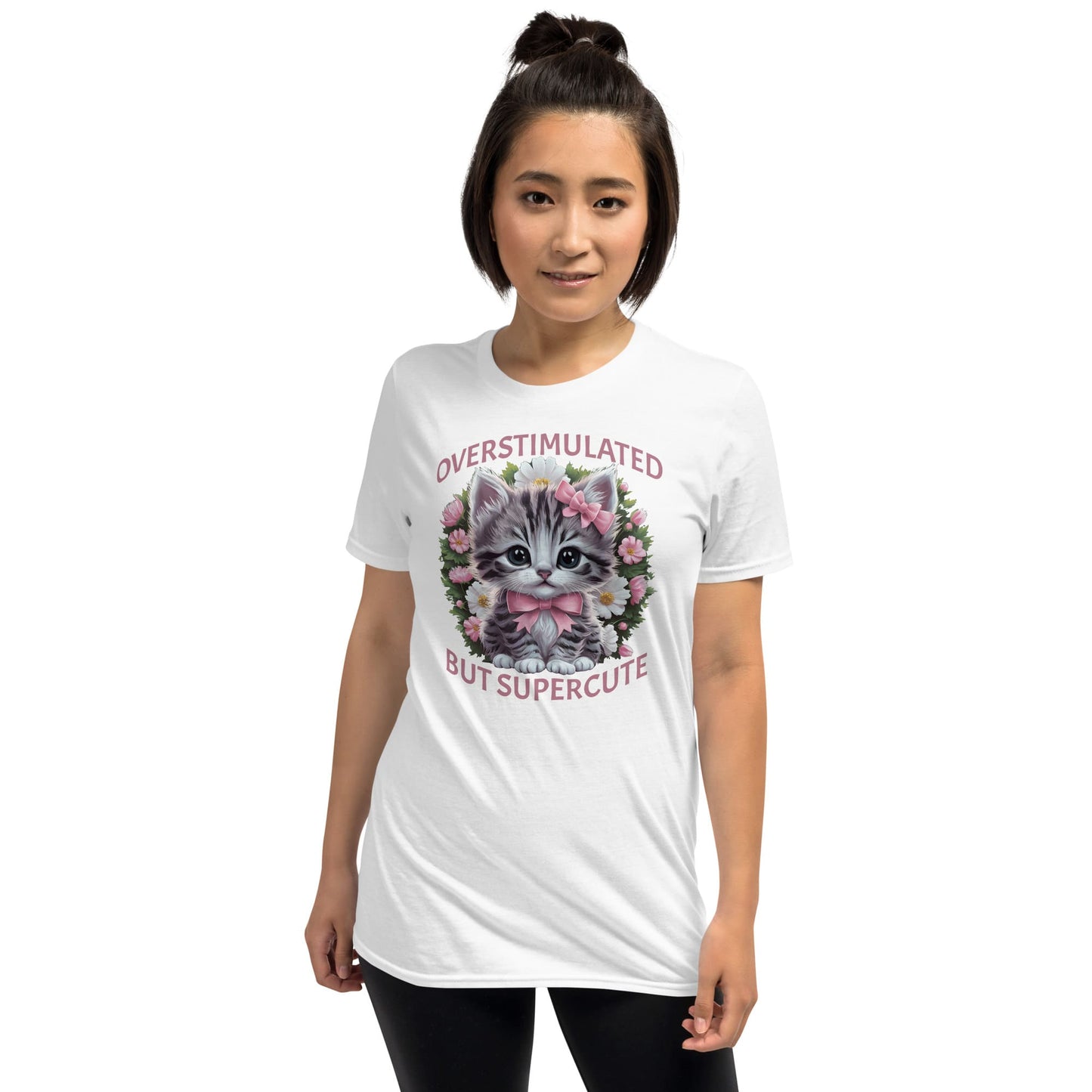 Person wearing a white t-shirt with a kitten graphic and text on a white background: Overstimulated Shirt, Neurodiversity Tee, ADHD Burnout Tshirt, Autism Awareness, Gift For Neurospicy Autistic, Cute Pink Bow Cat T-Shirt