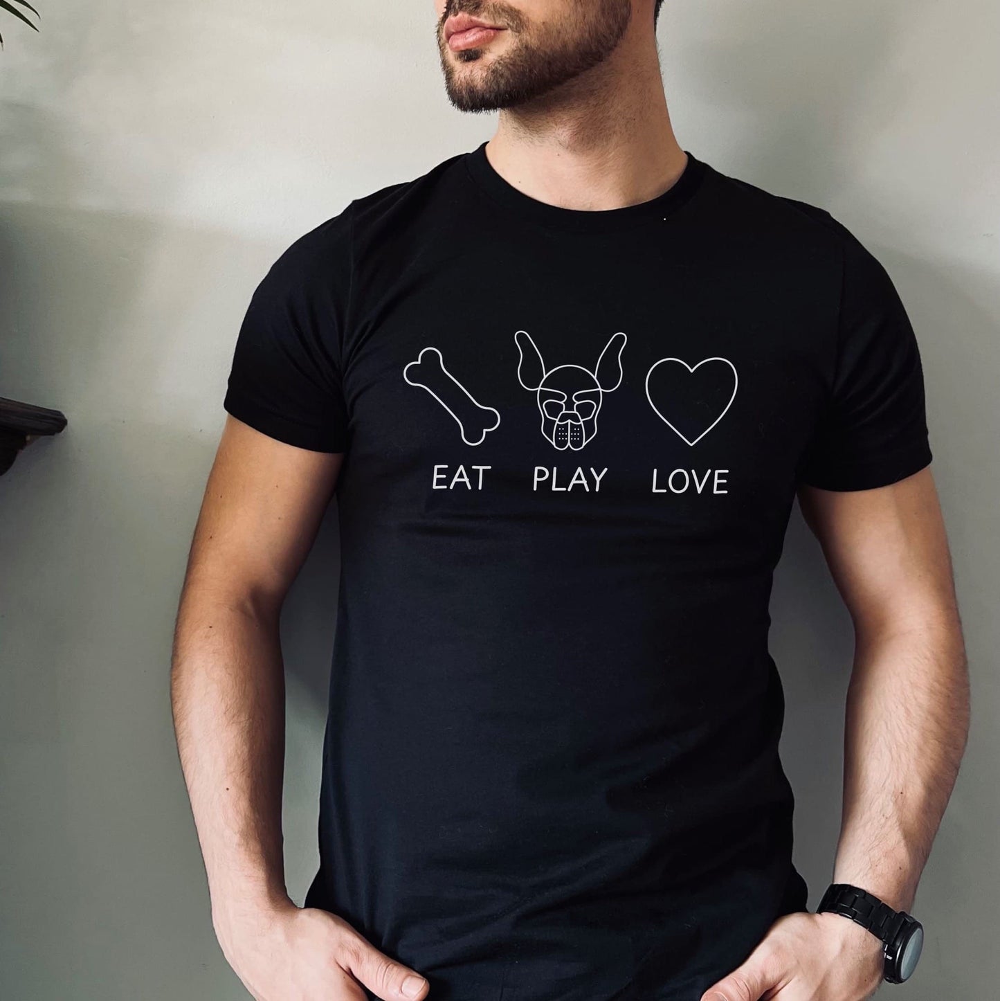 Person wearing a black t-shirt with white graphics and text on a plain background: Pup Play Shirt, Funny Pet Play Tee, Puppy & Handler T-shirts, Human Puppy Shirt, Puppy Hood Tee, Gift, Petplay Gift