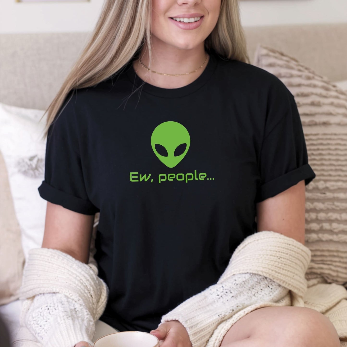 Person wearing a black t-shirt with an alien graphic and text, sitting on a couch: Funny Alien Shirt, Ew People Introvert Tee, Anxiety Shirt, Antisocial Sci-Fi Fans T-Shirt, Awkward Homebody, I hate People