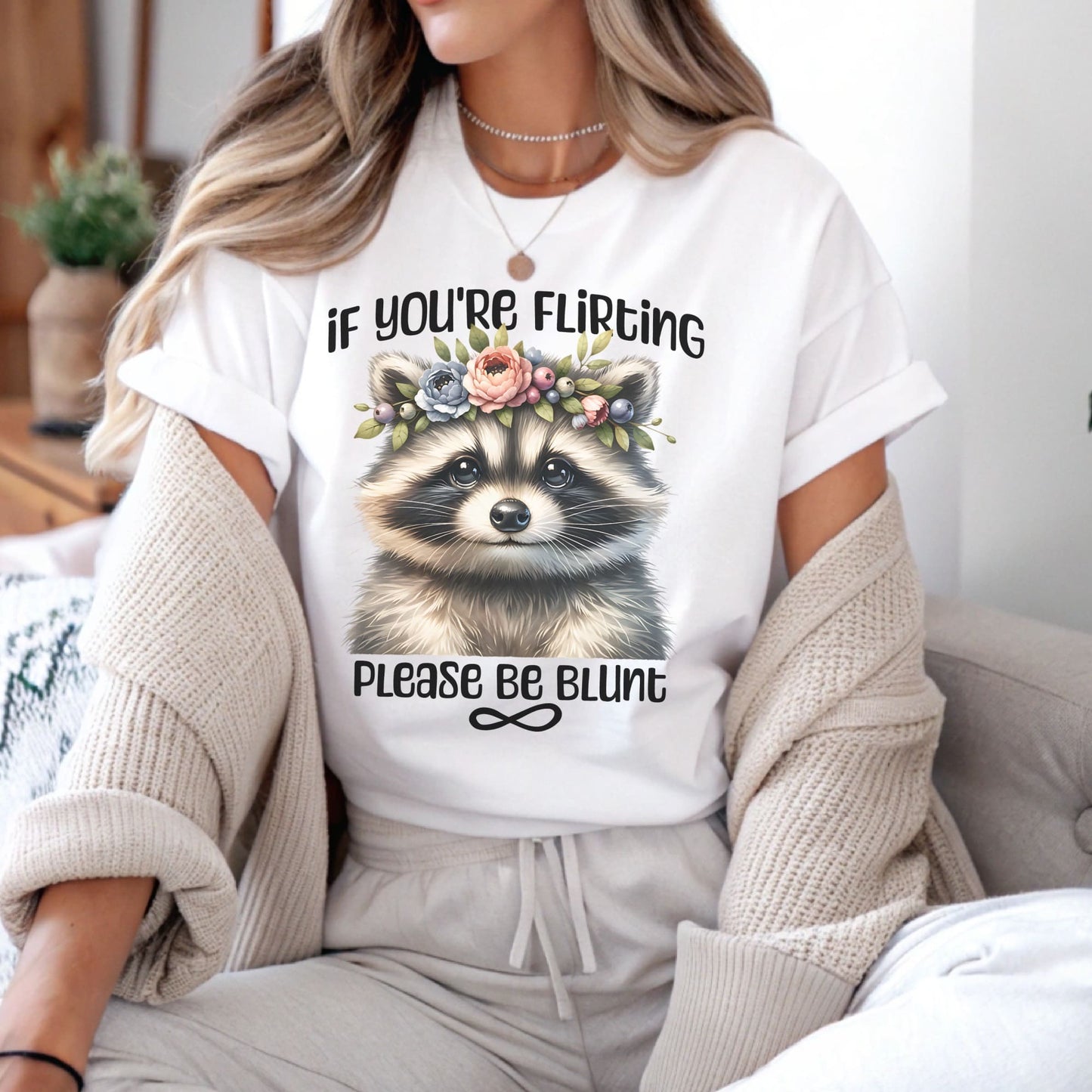 Person wearing a white t-shirt with a raccoon graphic and text, sitting on a couch: Subtle Neurodivergent Shirt, Autism Awareness Tee, ADHD AuDHD Warrior T-Shirt, Cute Raccoon Shirt For Neurospicy, Neurodivergent Gift