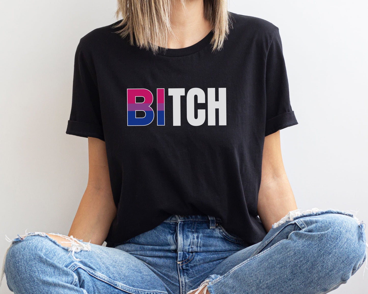 Person wearing a black t-shirt with Bi bitch design