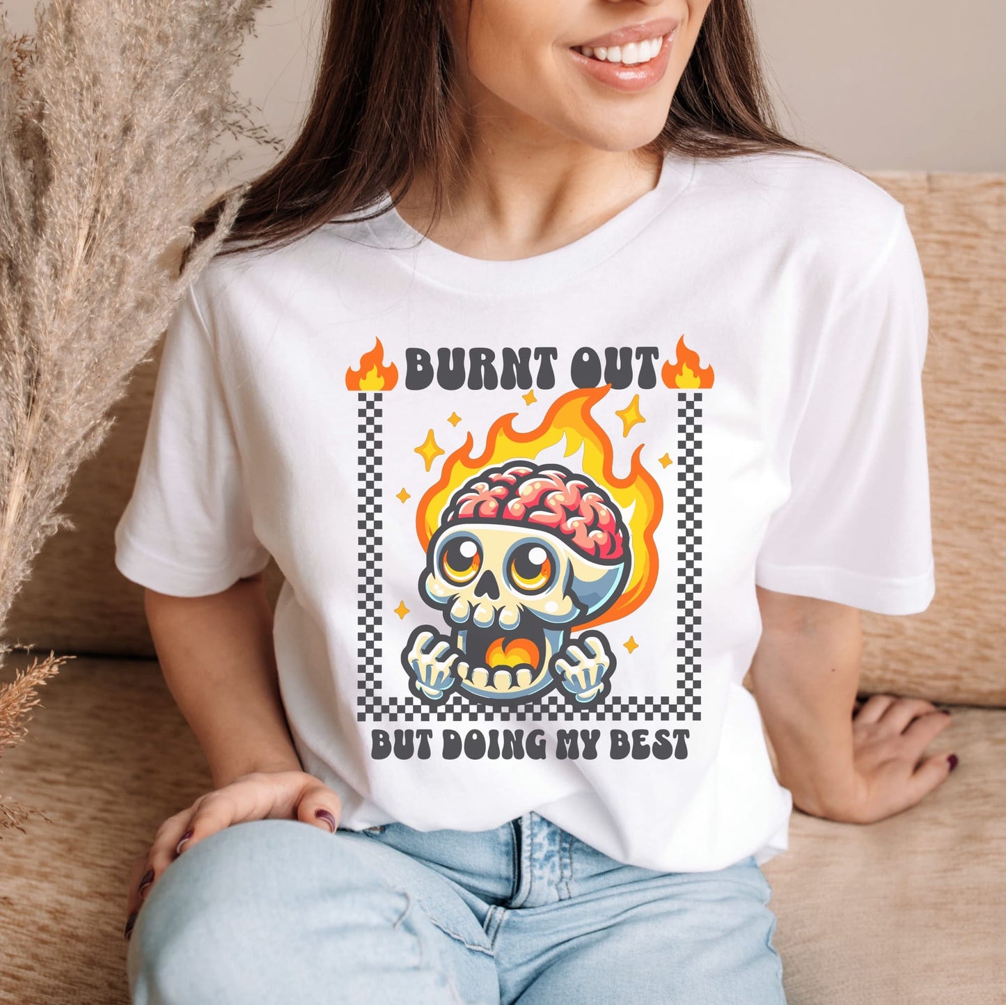 Person wearing a white t-shirt with a graphic design featuring a skull and flames: Funny Mental Health Shirt, Burnout Tee, Retro Neurodivergent T-Shirt, Cute Skull Gift For Autism Warrior, Overstimulated Shirt For Depressed