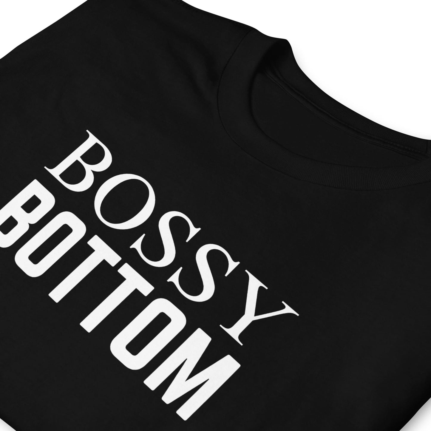 Black t-shirt with queer 'BOSSY BOTTOM' text in white on a white background