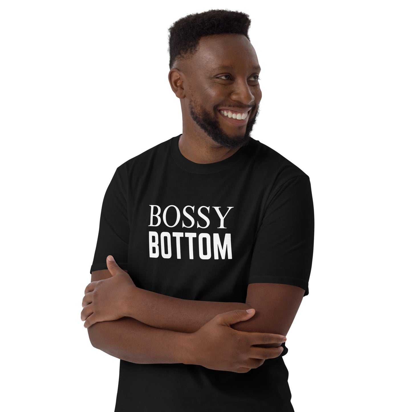 Queer man wearing a black t-shirt with 'BOSSY BOTTOM' text on a white background