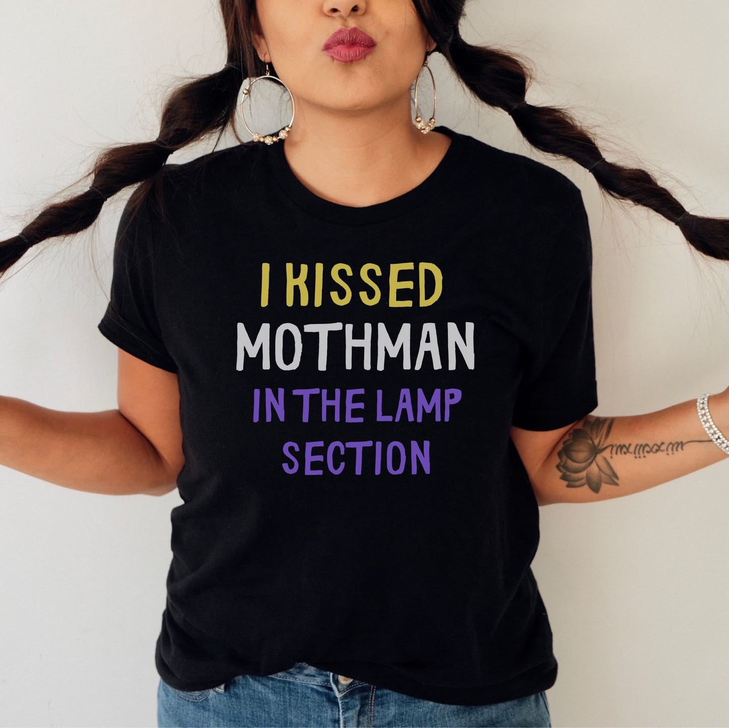 Person wearing a black t-shirt with humorous text design: Nonbinary Humor Shirt, Funny Mothman Cryptid Tee, Spooky Queer Pride Gift, LGBTQ Meme T-Shirt ,Enby Weirdcore Top, Cryptidcore Mythology
