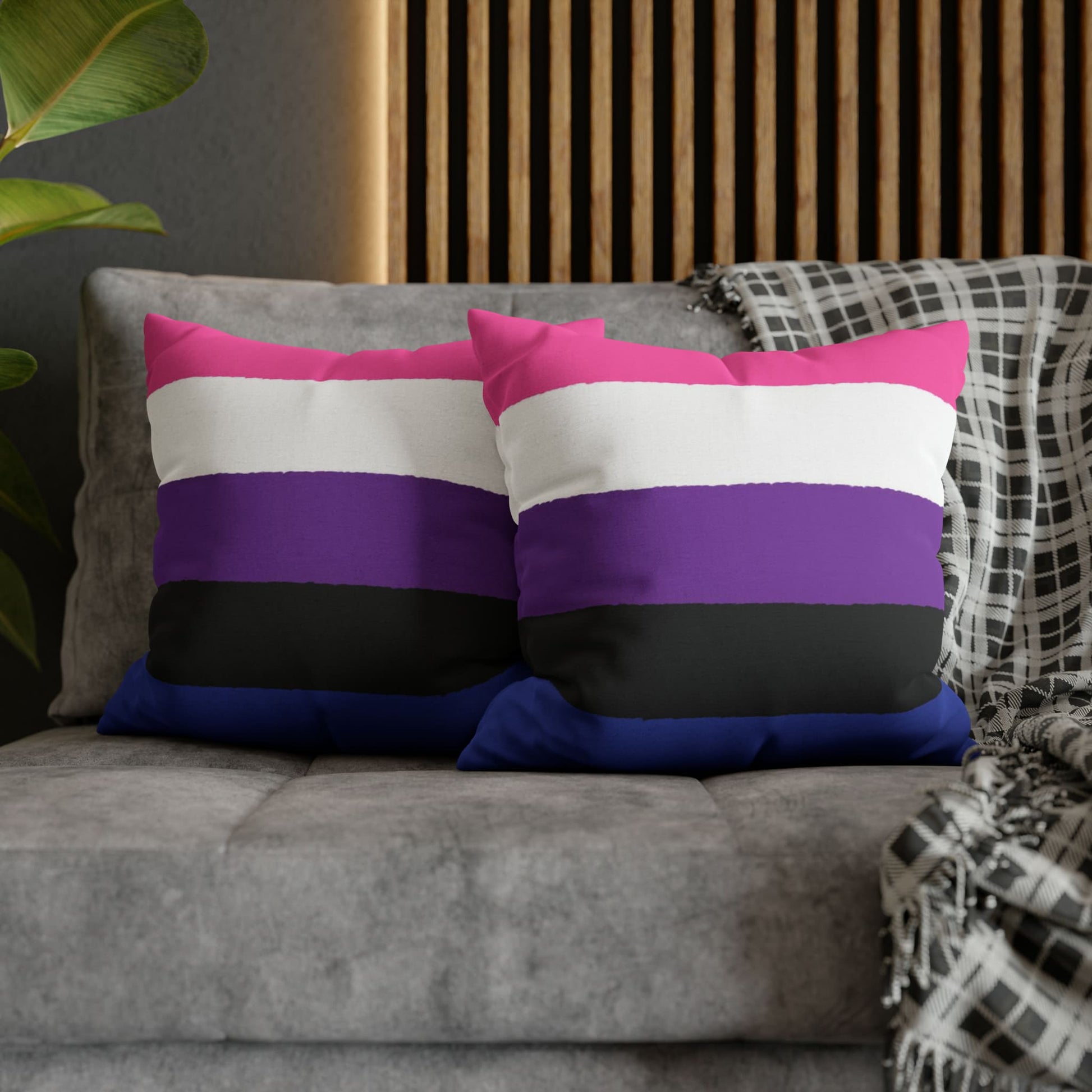 2 genderfluid pillows on couch