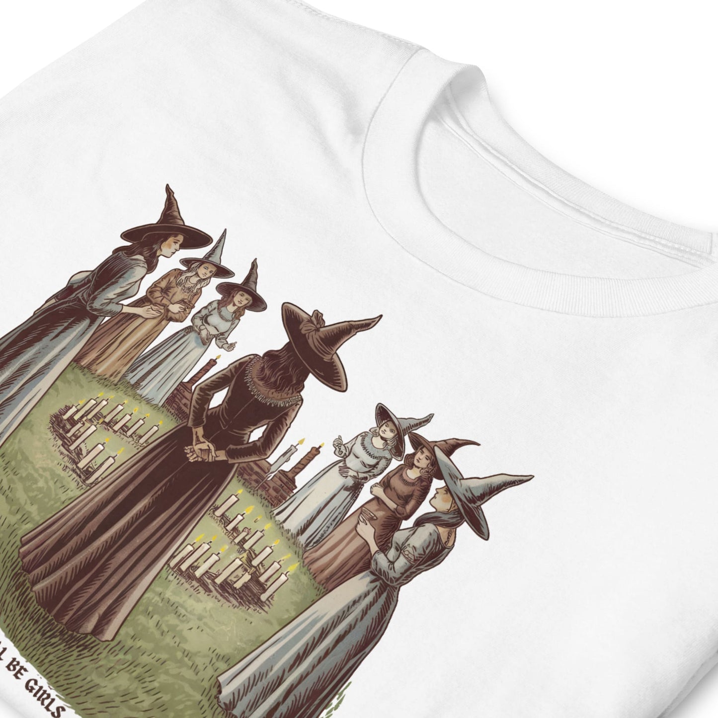 White t-shirt with vintage-style graphic of witches and a broomstick on a white background