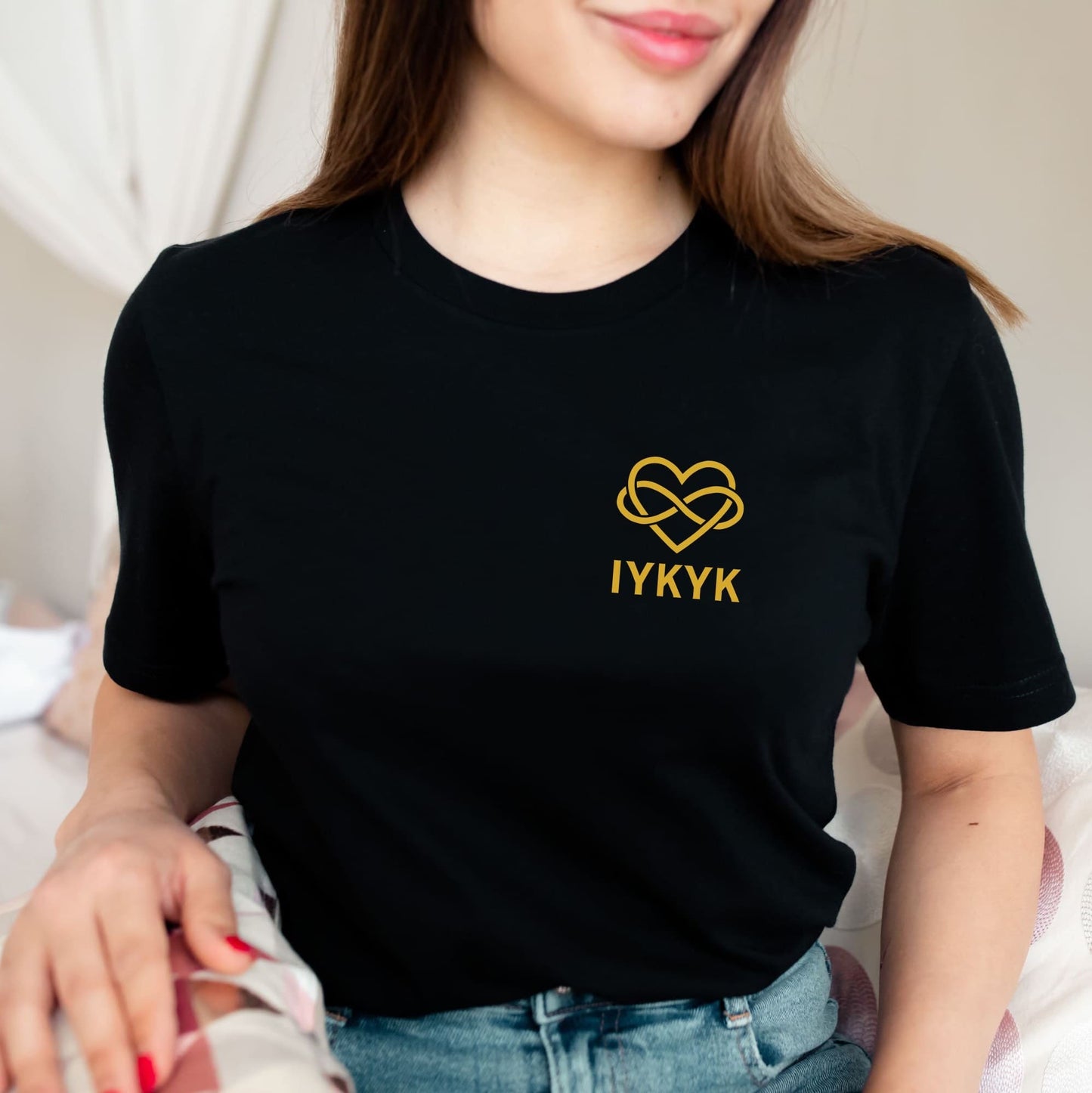 Person wearing a black t-shirt with a gold heart ENM design and 'IYKYK' text: Subtle Polyamory Shirt, Funny Open Relationship Tee, Polyamorous Pride T-Shirt, Non Monogamy, Polycule Gift For Big Middle Little Spoon