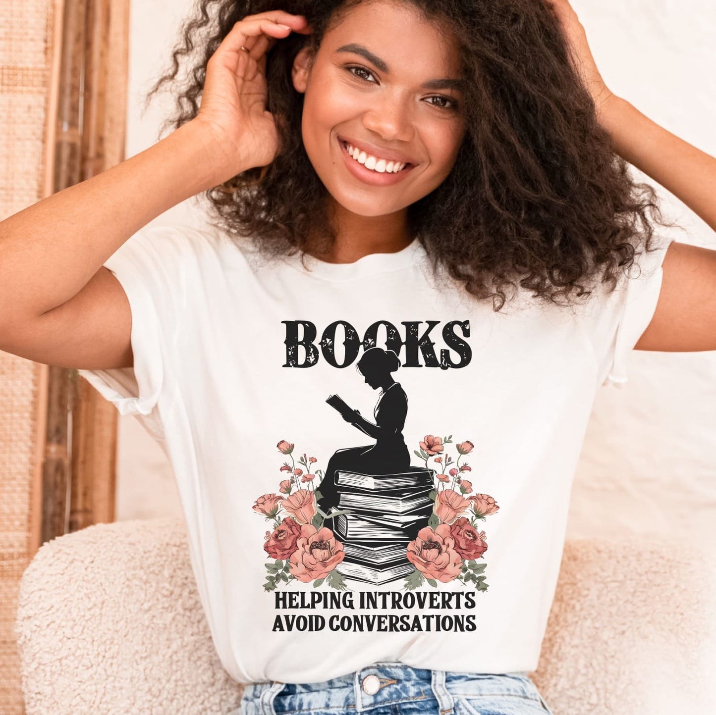 Woman wearing a white t-shirt with a book-themed design for introverts