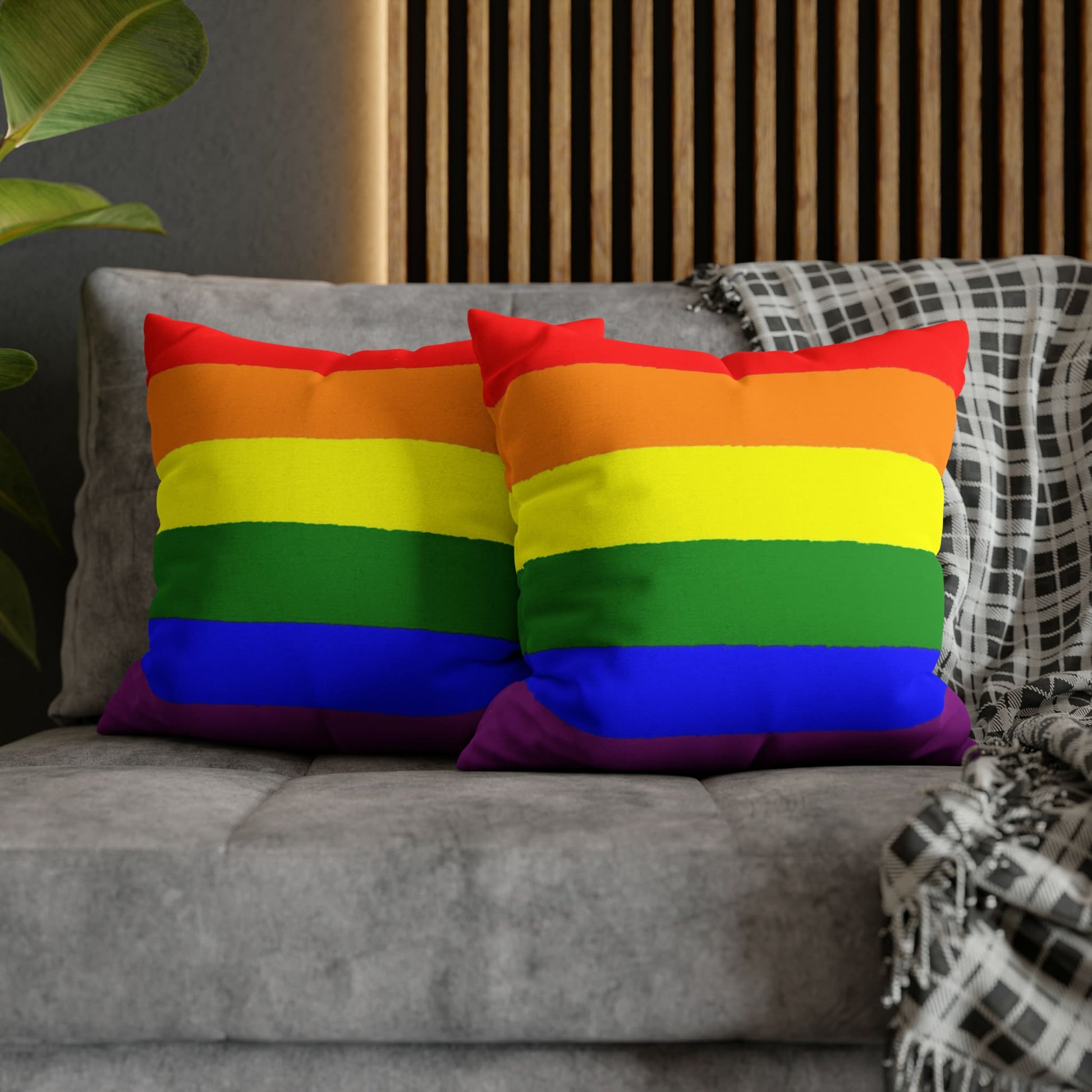 2 LGBTQ pride pillows on couch