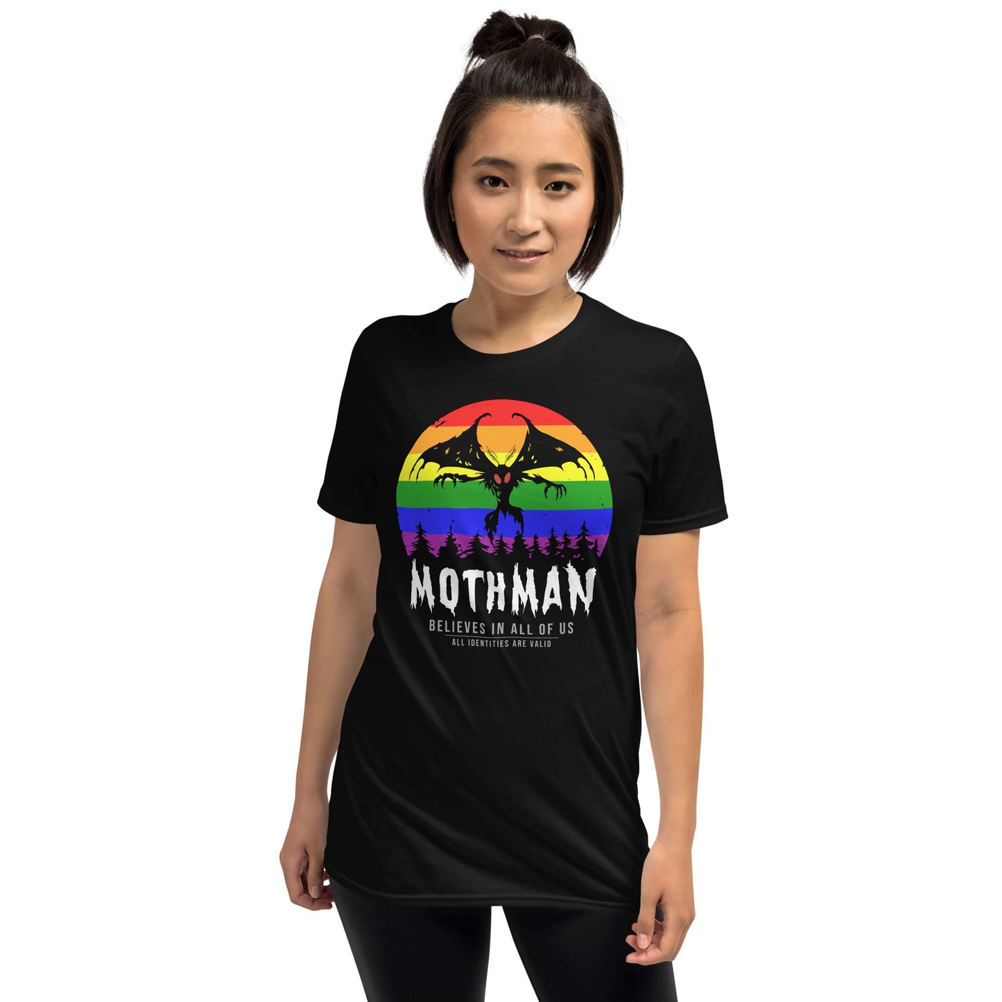 Person wearing a black t-shirt with a rainbow Mothman graphic and text: LGBTQ Mothman Shirt, Rainbow Pride Cryptid Folklore T-Shirt, Queer Mythology Legend Cryptozoology Tee, Cryptidcore Weirdcore Gift For LGBT