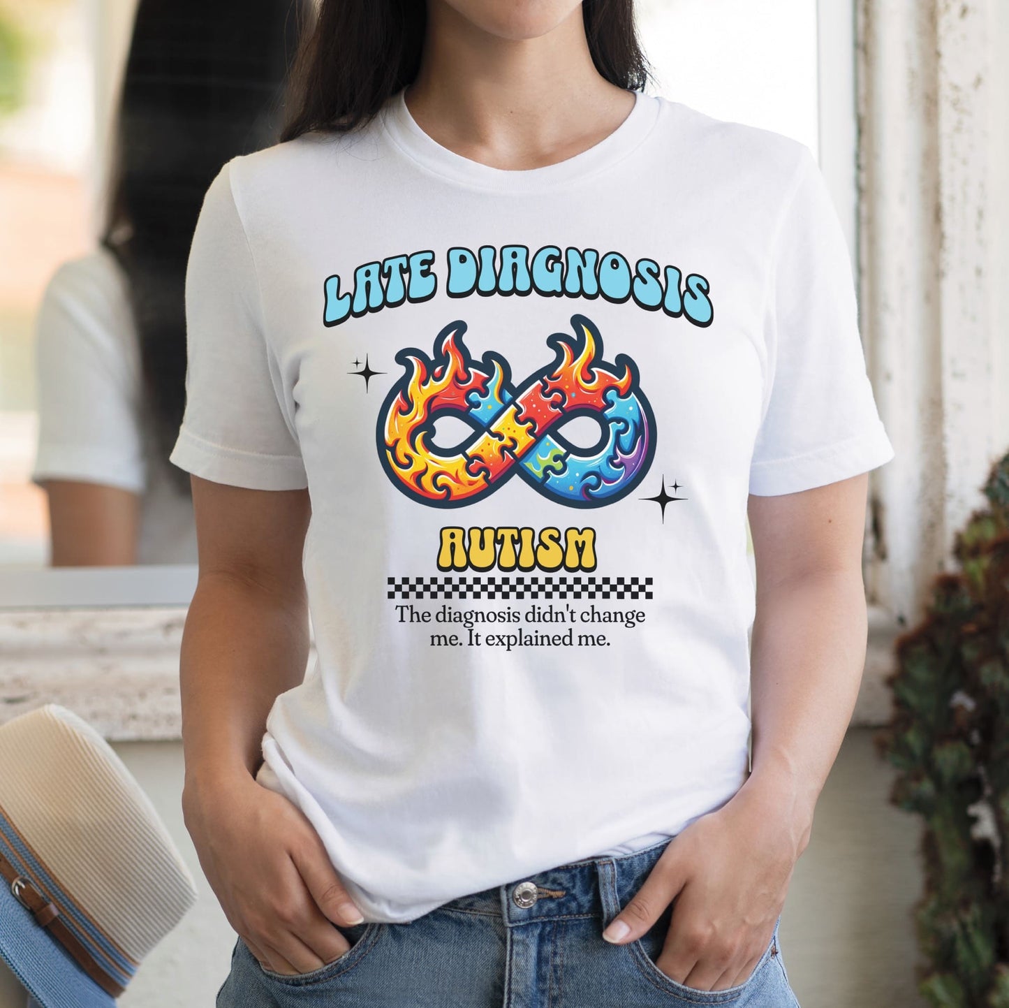 Person wearing a white t-shirt with colorful design and text: Late Diagnosis Autism Shirt, Neurodiversity In Adult Tee, Neurodivergent T-Shirt, AuDHD Neurospicy Brain, Mental Health Gift For Therapist