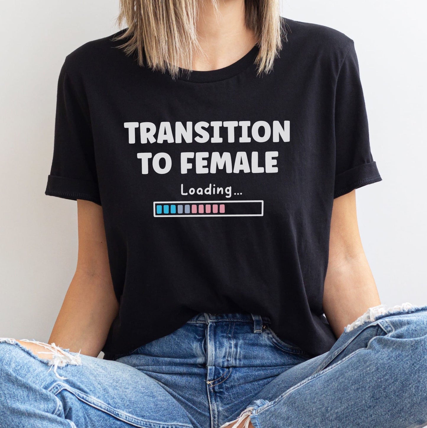 MTF person wearing a black transgender t-shirt with 'Transition to Female Loading' text.