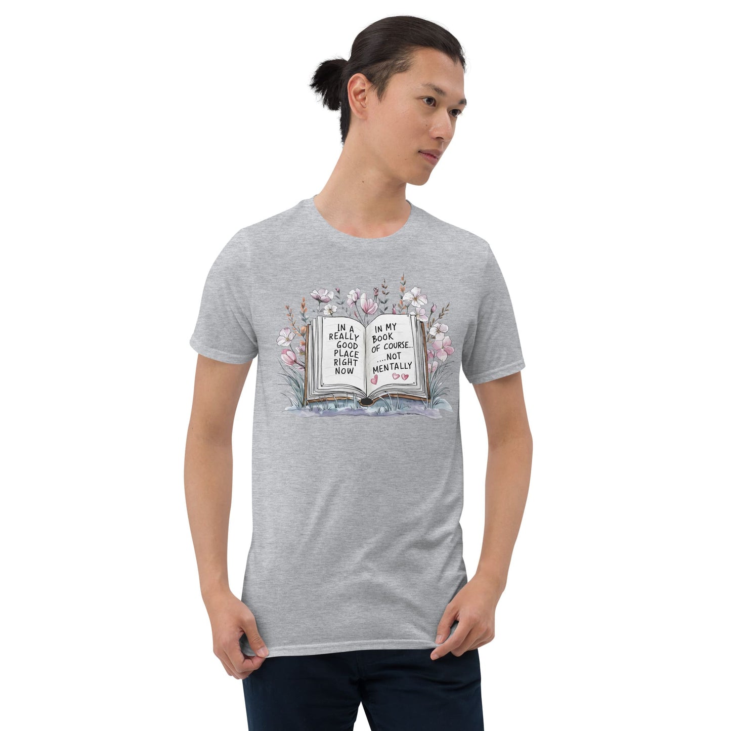 Person wearing a gray t-shirt with a book graphic and text on a white background