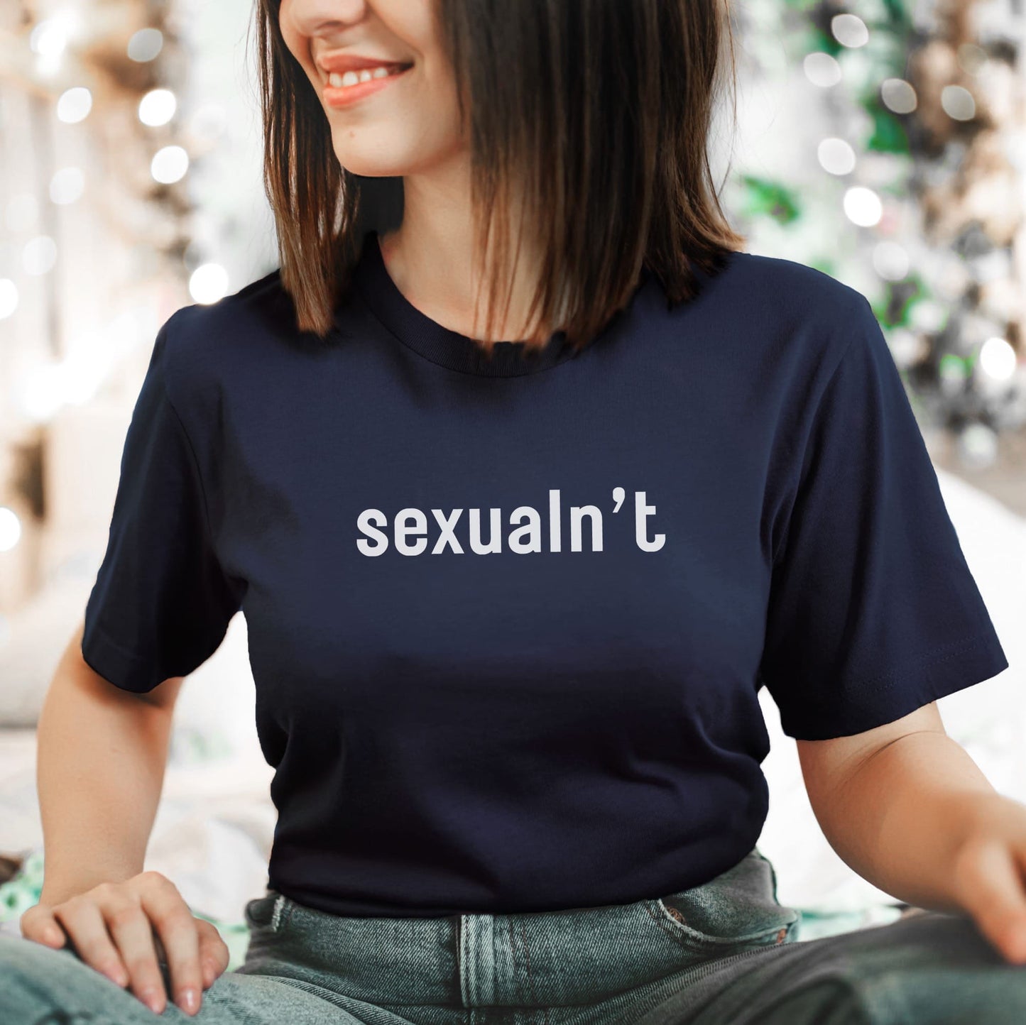 Person wearing a navy blue asexual t-shirt with 'sexualn't' text.