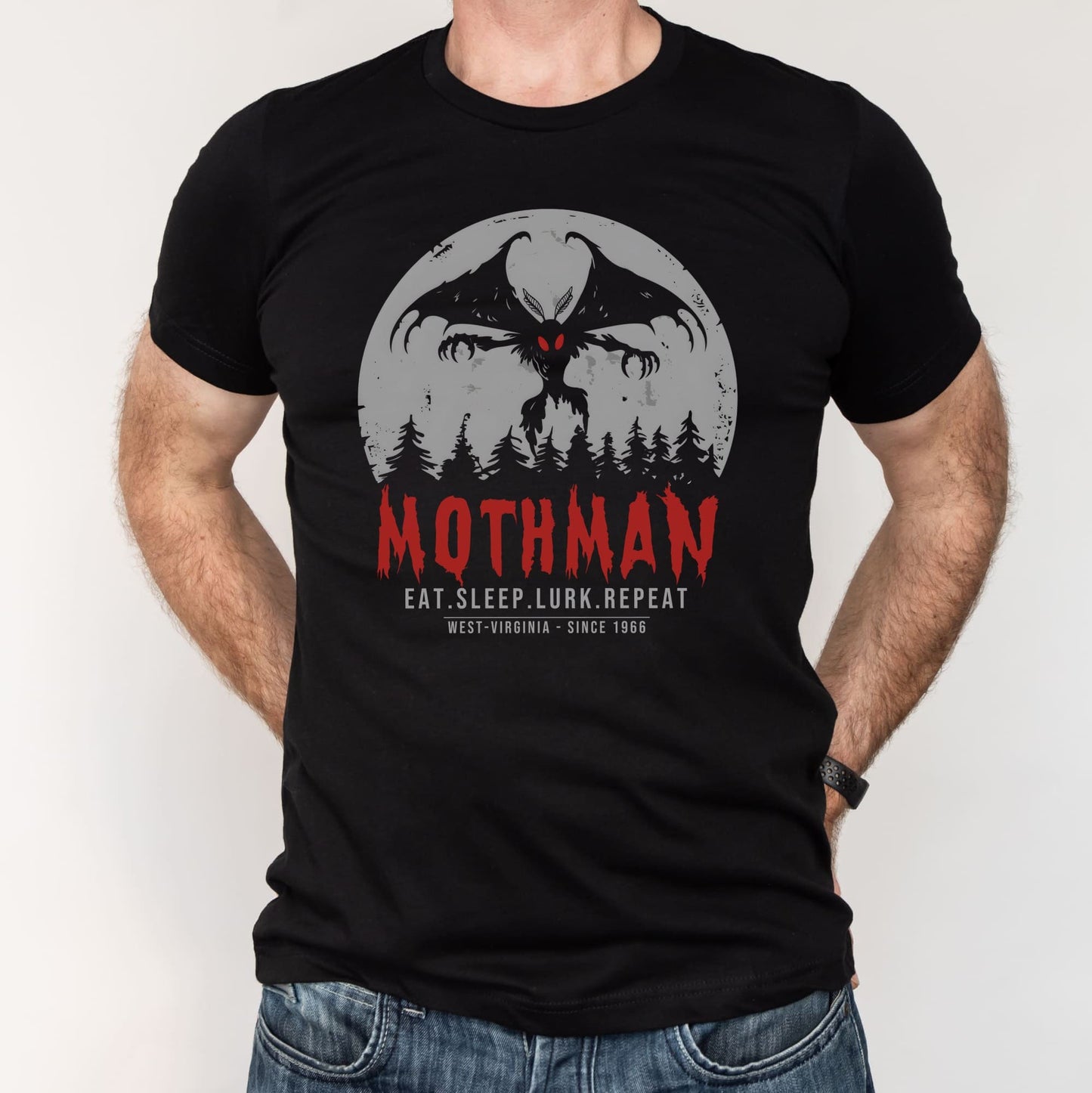 Black t-shirt with Mothman graphic and text on a white background