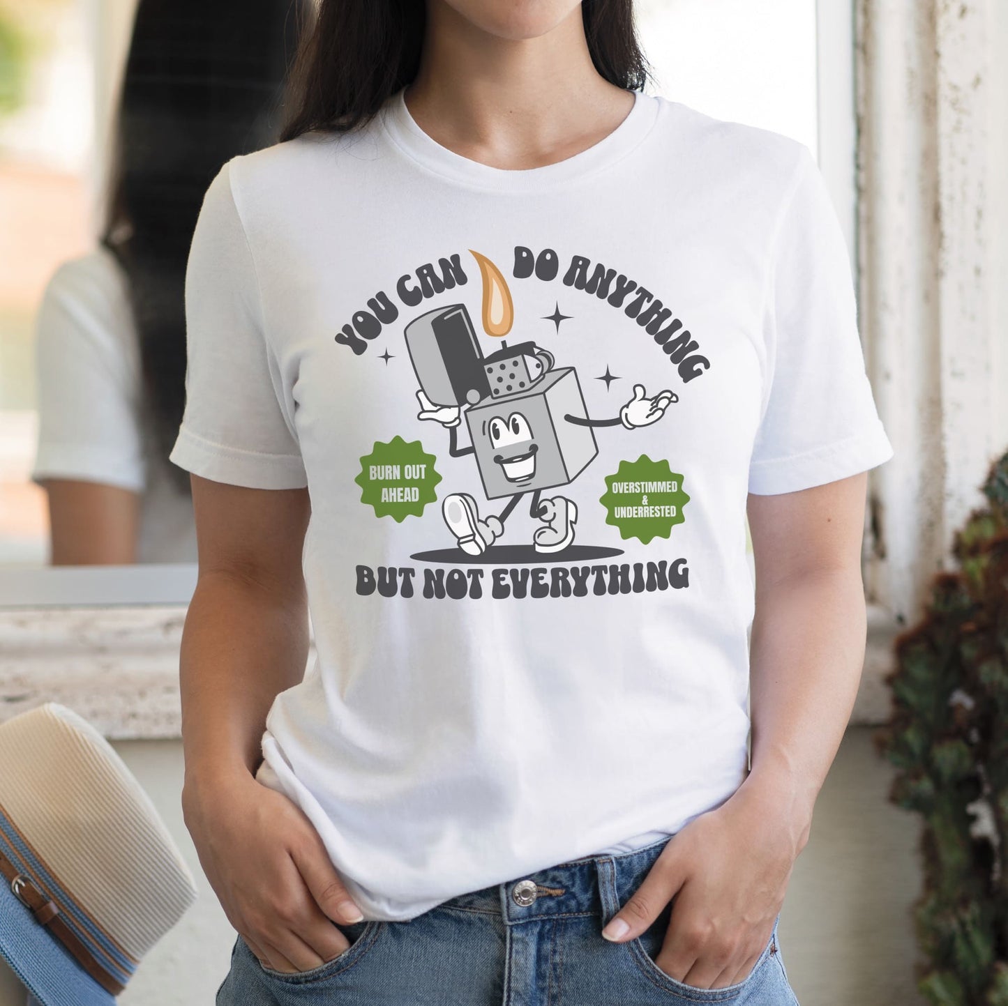 Person wearing a white t-shirt with a graphic design and text: Funny Overstimulated Shirt, Motivational Mental Health Tee, Autism Awareness T-Shirt, ADHD AuDHD Burnout Tshirt, Sped BCBA Teacher Gift