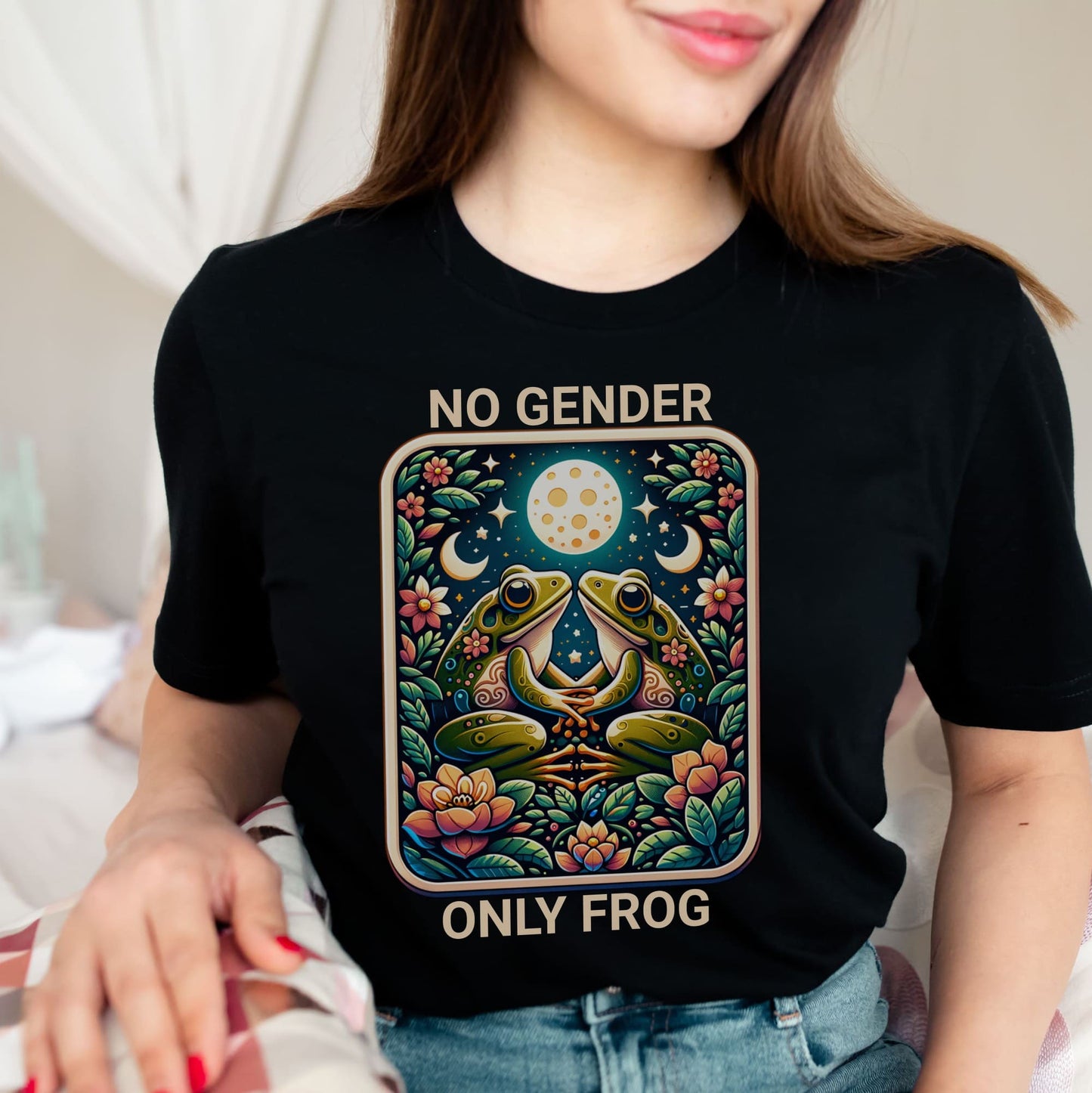 Enby Person wearing a black t-shirt with a colorful graphic of two frogs and text 'NO GENDER ONLY FROG'.