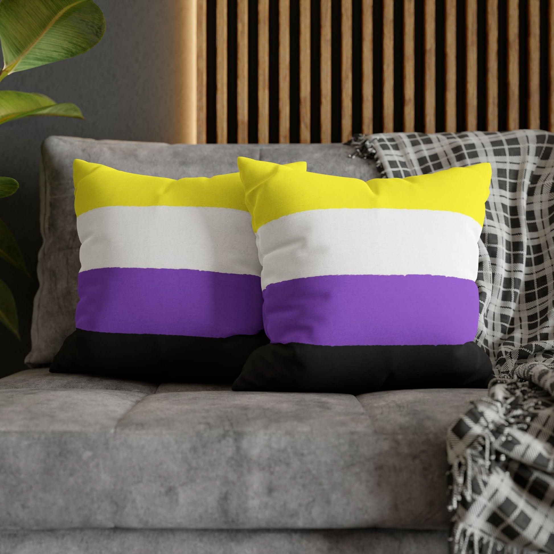 2 nonbinary pillows on couch
