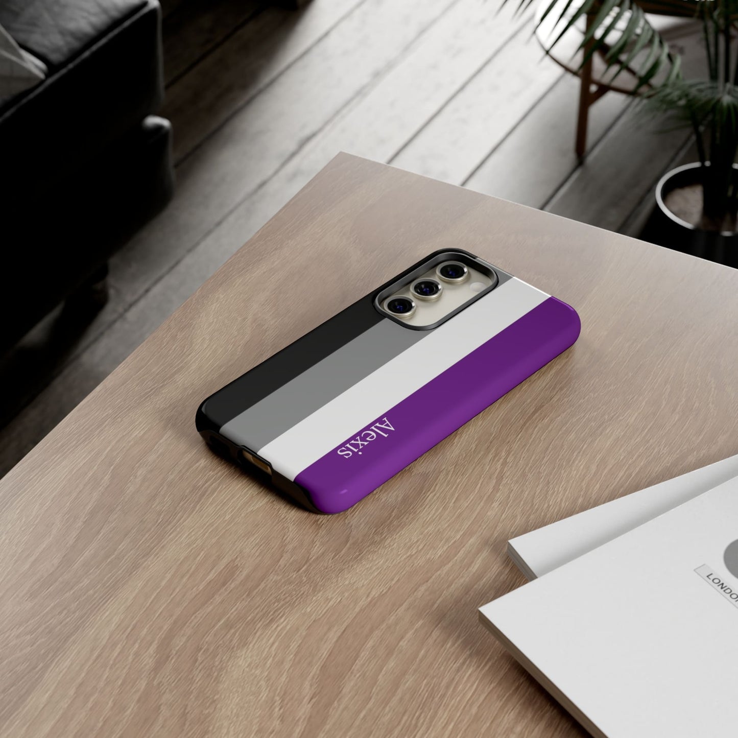 asexual flag phone case, on table