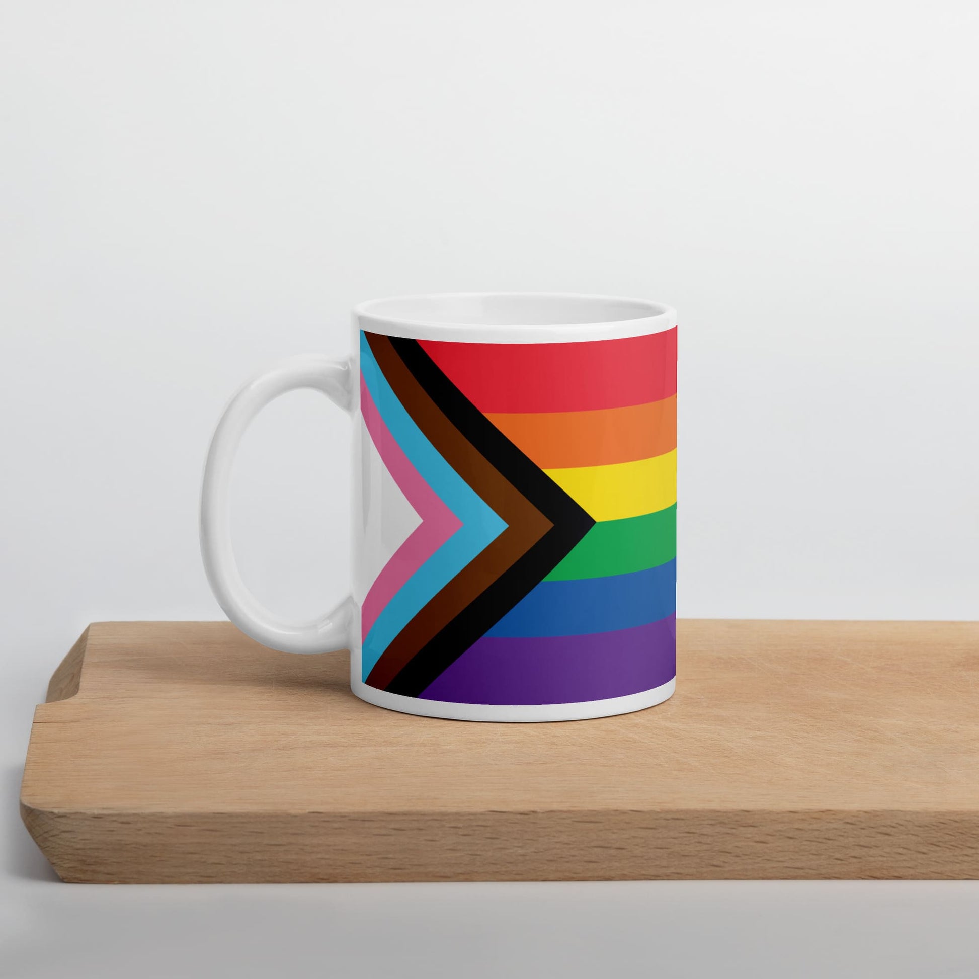 progress pride coffee mug on table