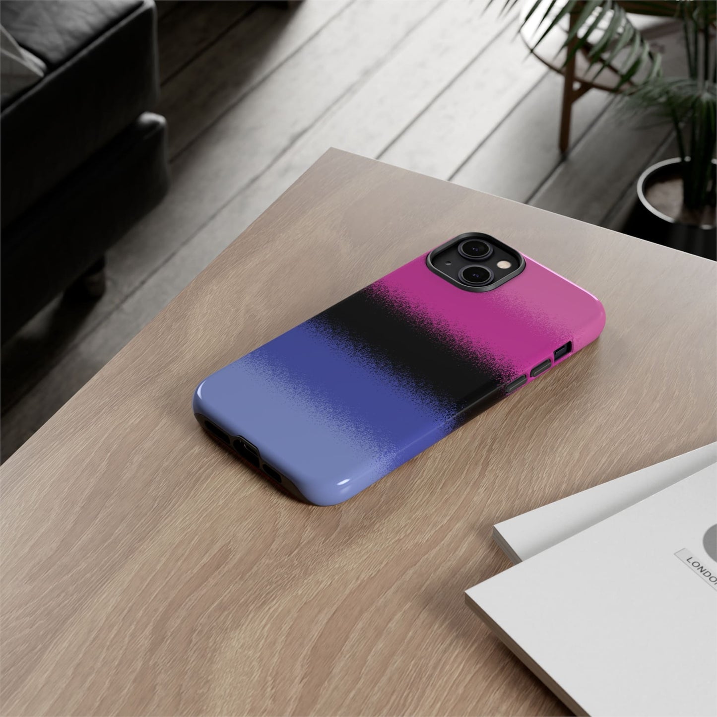 Omnisexual phone case sprayed flag, on table