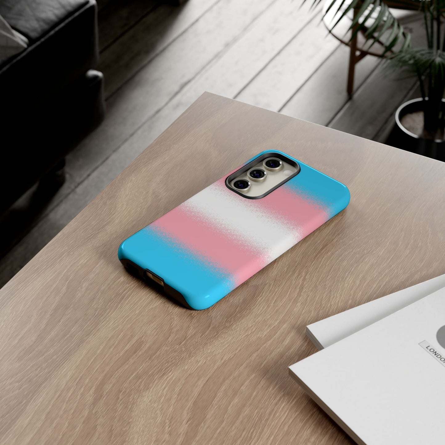 Transgender phone case sprayed flag, on table