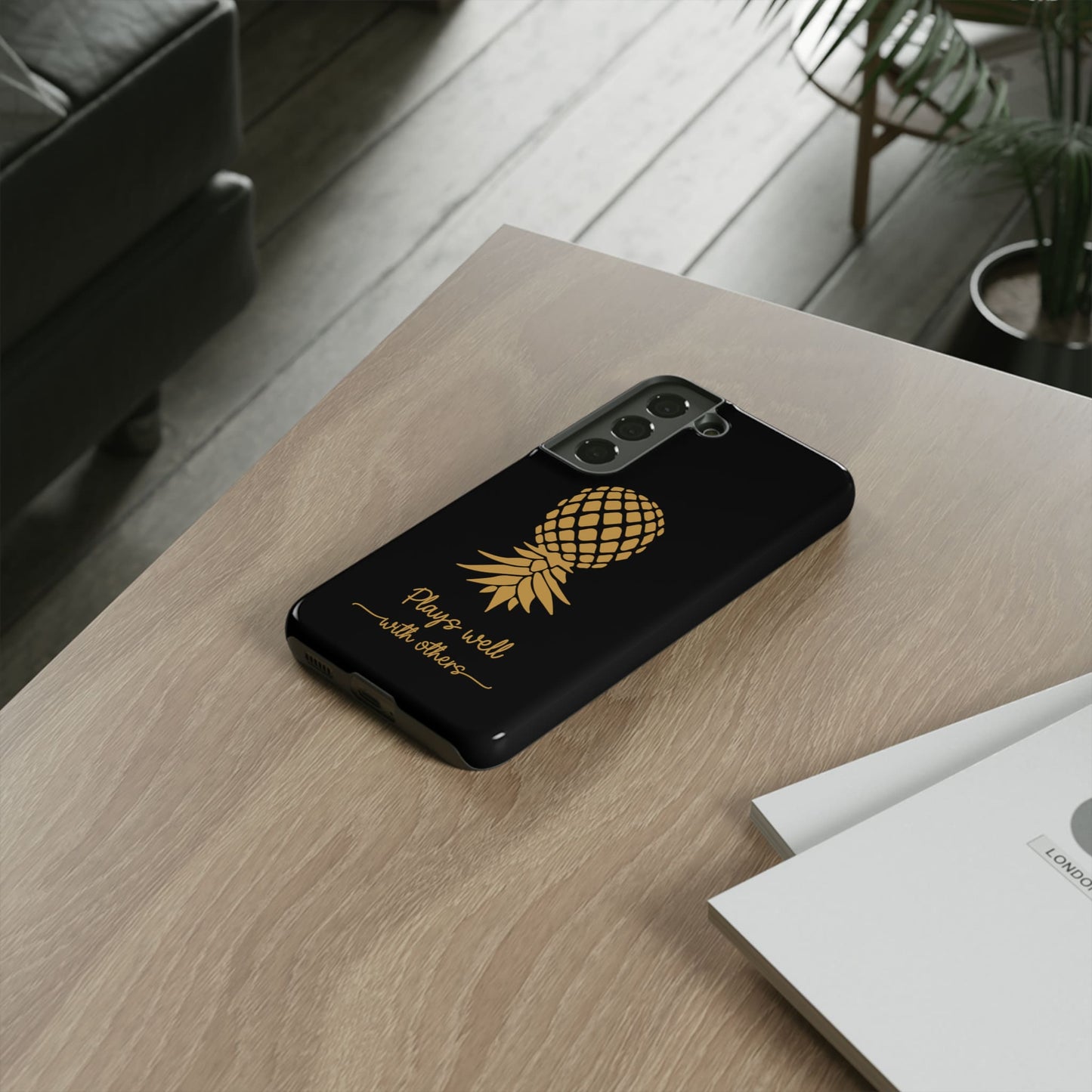 Swingers upside down pineapple phone case, on table
