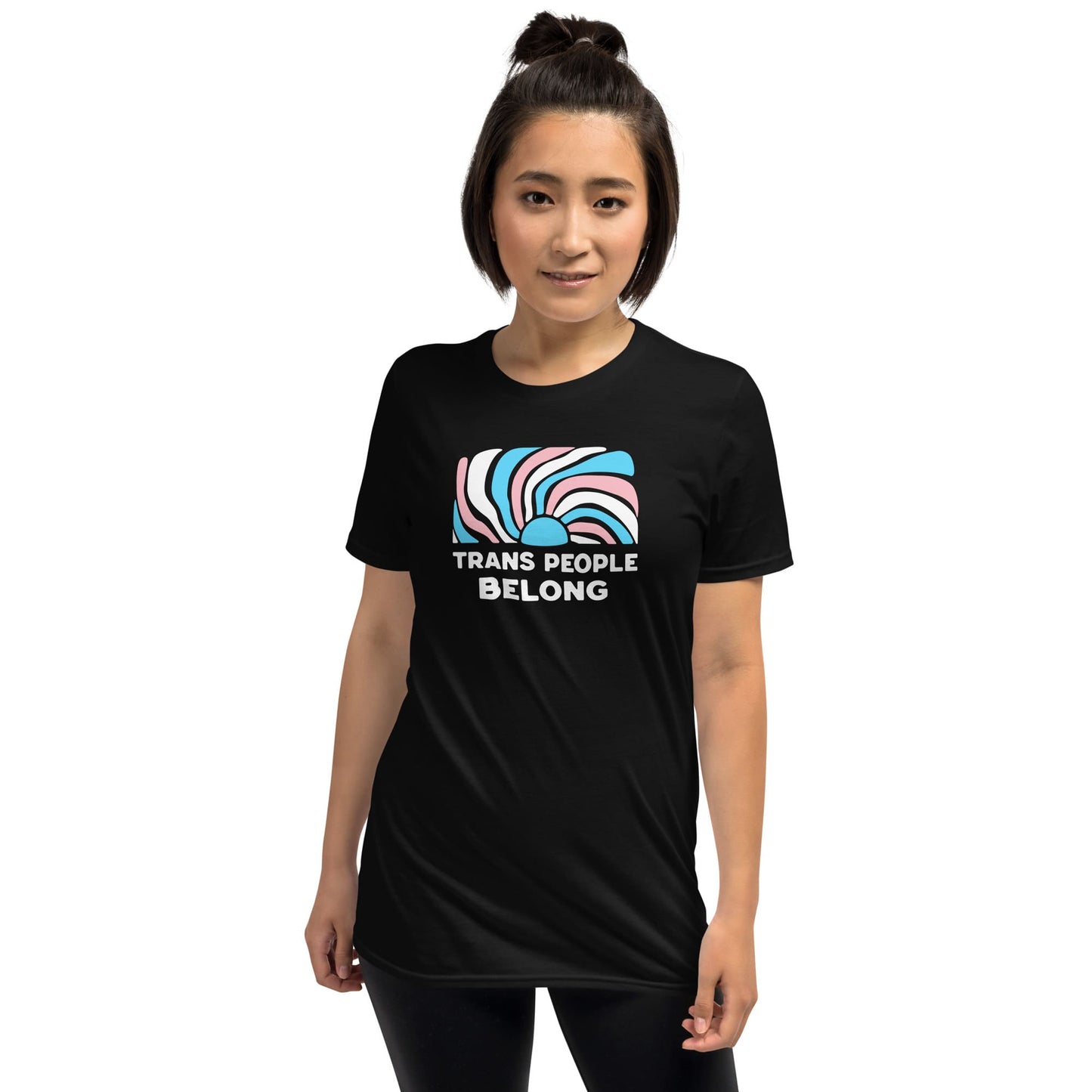 Person wearing a black t-shirt with 'Trans People Belong' text and abstract design on a white background