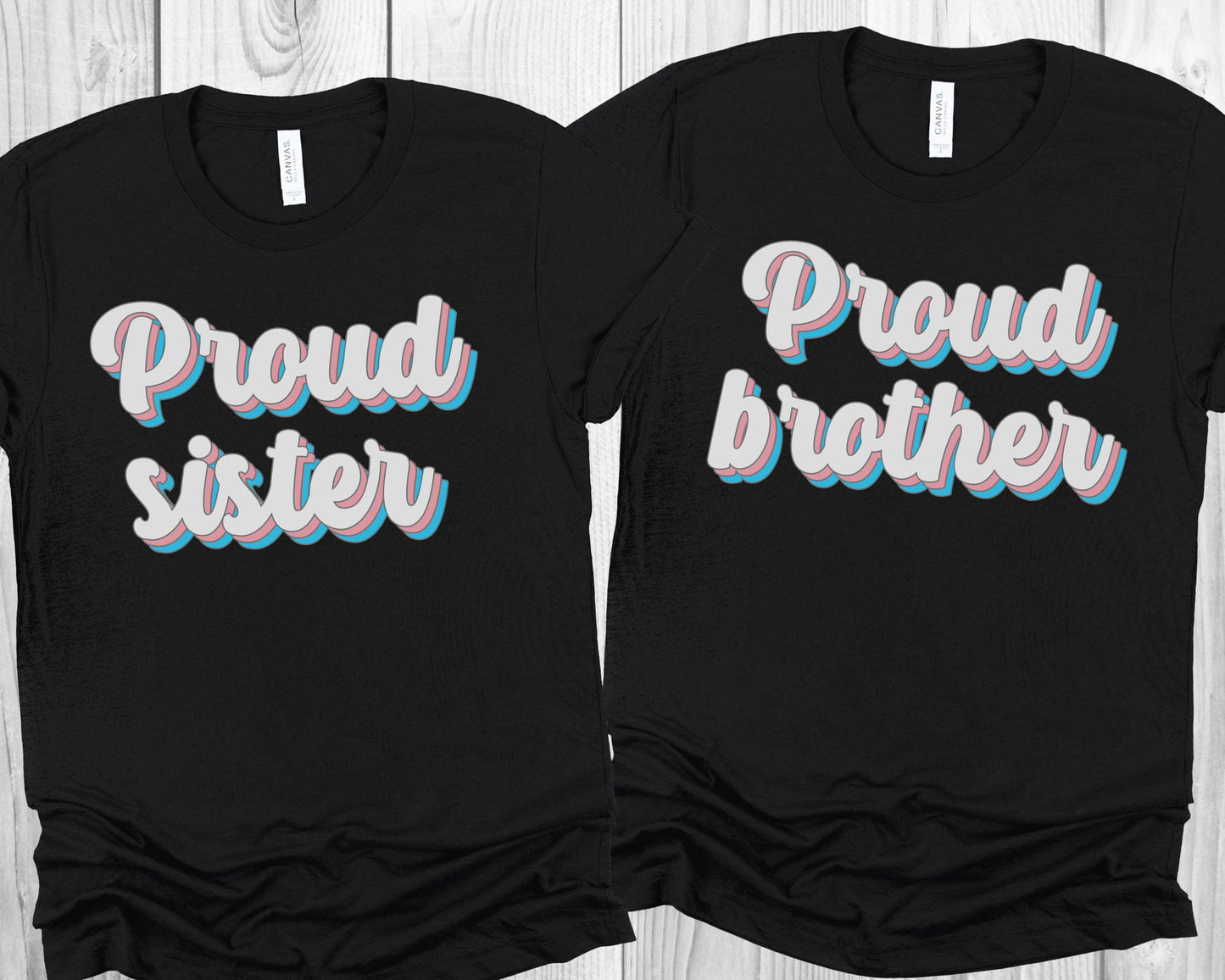 matching transgender t-shirts with 'Proud sister' and 'Proud brother' text on a wooden surface.