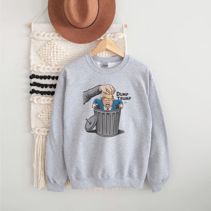 Gray sweatshirt with 'Dump Trump' graphic on a hanger against a white wall.