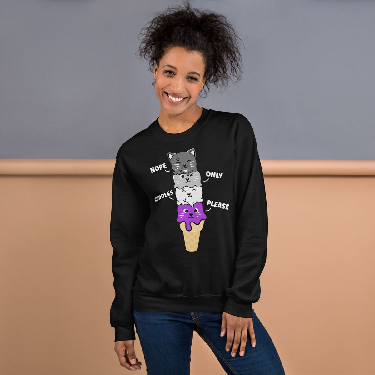 Person wearing a black asexual  sweatshirt with a cat ice cream graphic design.