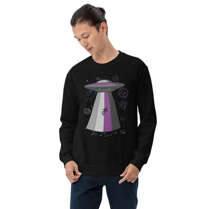 Person wearing a black asexual sweatshirt with a UFO graphic on a white background