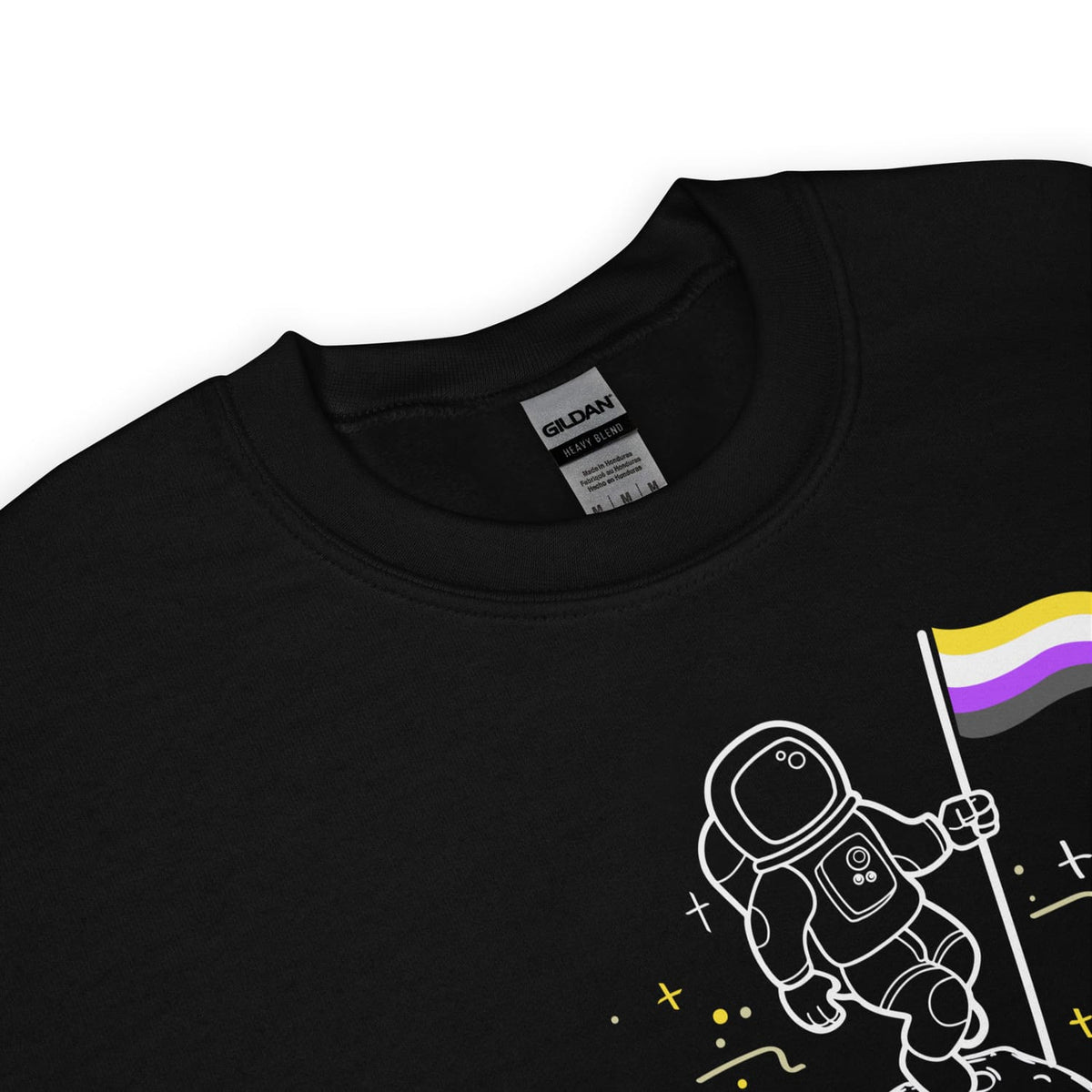 Detail of enby pride sweatshirt with an astronaut holding a flag featuring a non-binary pride symbol, brand label visible.