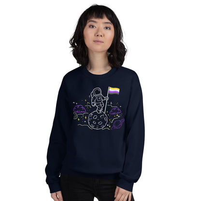 Person wearing a navy blue nonbinary sweatshirt with a space-themed design on a white background