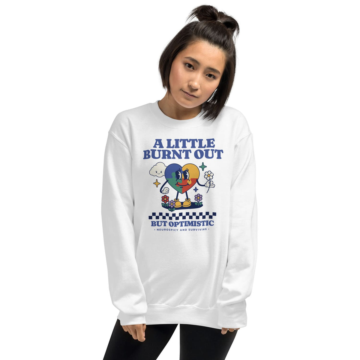 Person wearing a white neurodivergent sweatshirt with a colorful graphic and text on a white background