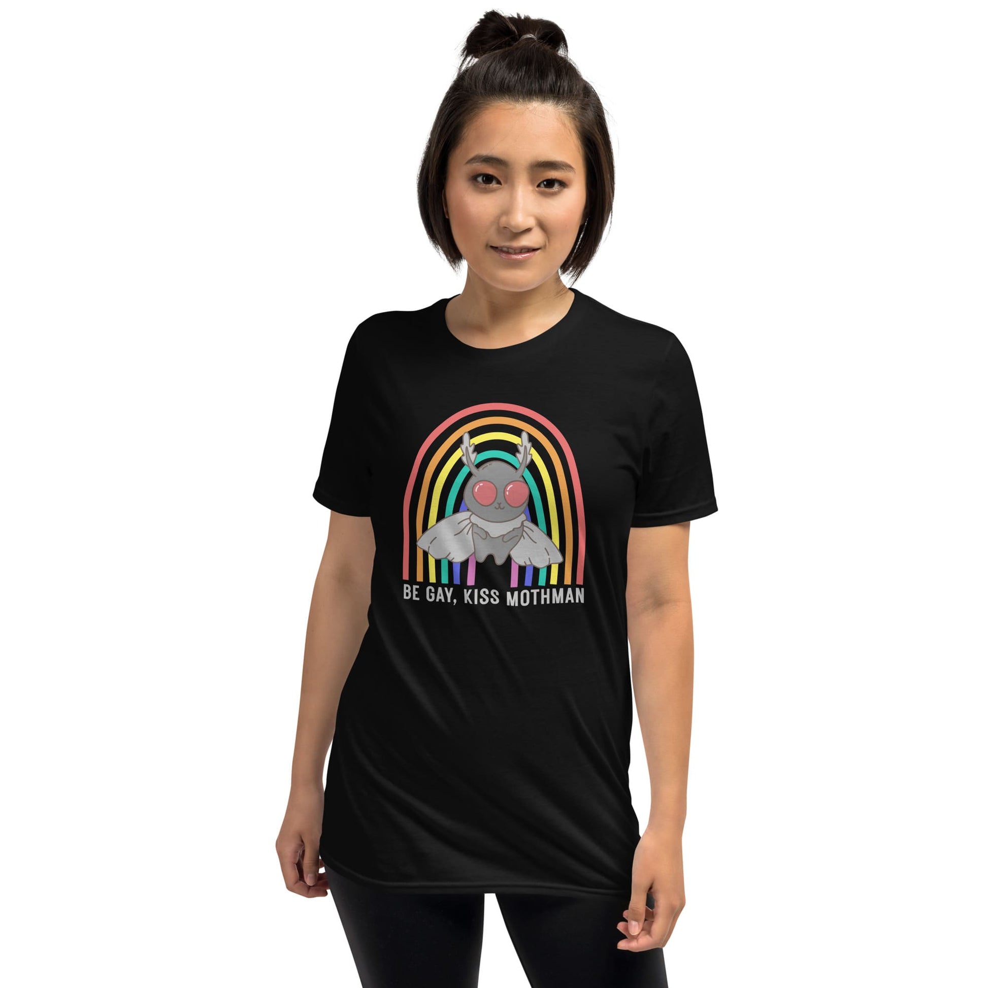 Person wearing a black t-shirt with a rainbow and Mothman graphic on a white background: LGBTQ Mothman Comfort Colors Shirt, Be Gay Kiss Mothman Tee, Queer Cryptid T-Shirt, LGBT Cryptidcore Gift, Rainbow Cryptozoology Merch