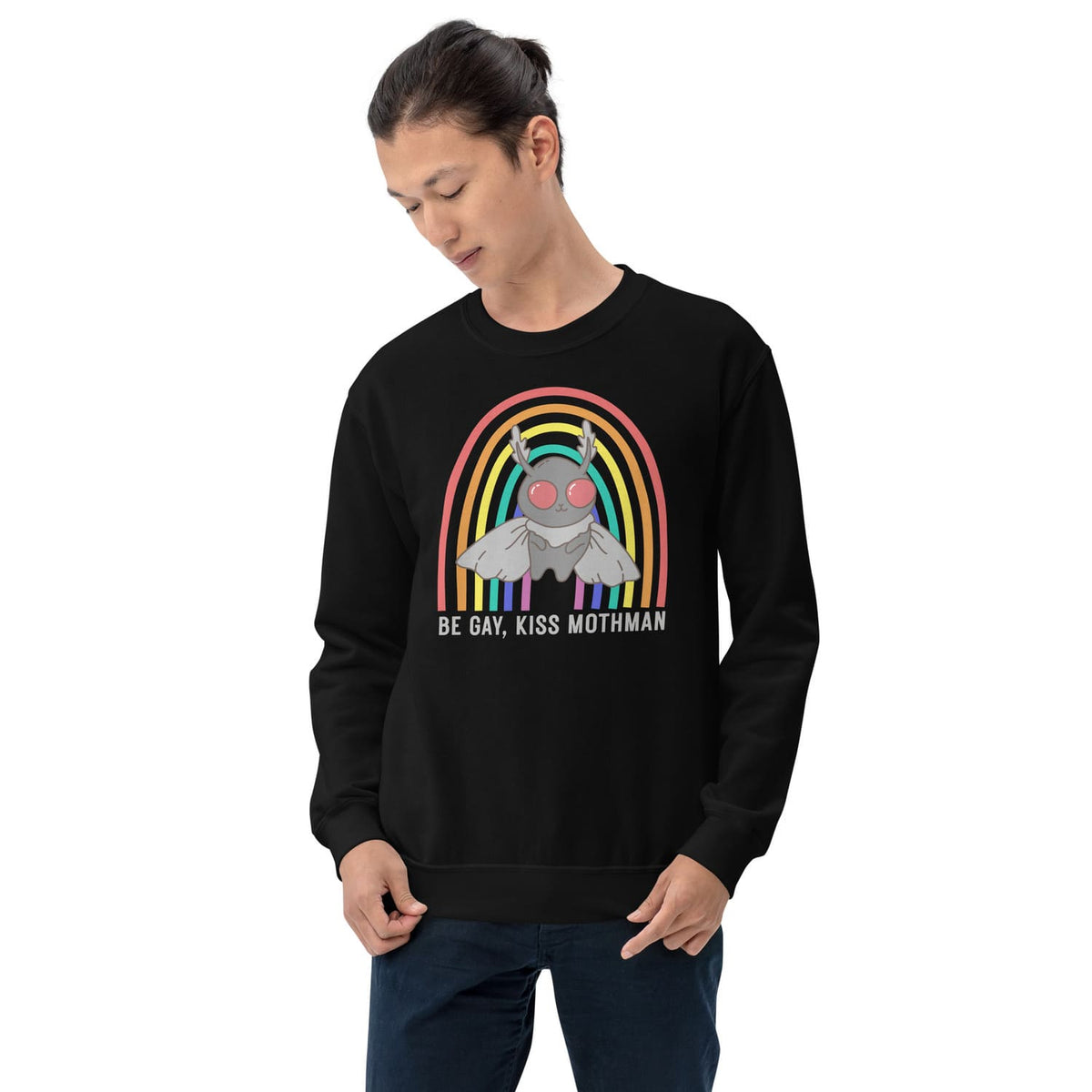 Person wearing a black sweatshirt with a graphic design of Mothman under a rainbow and text 'Be Gay, Kiss Mothman' on a white background.