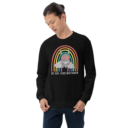 Person wearing a black sweatshirt with a graphic design of Mothman under a rainbow and text 'Be Gay, Kiss Mothman' on a white background.