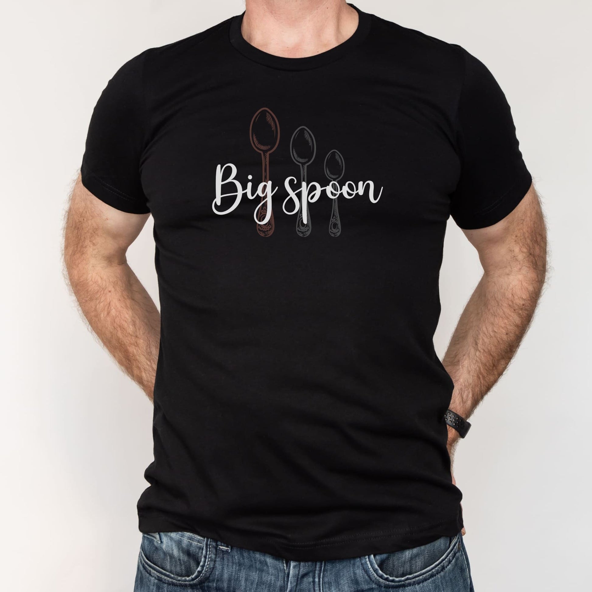 Black t-shirt with 'Big spoon' text and spoon graphics worn by a ENM polyamory person on a white background