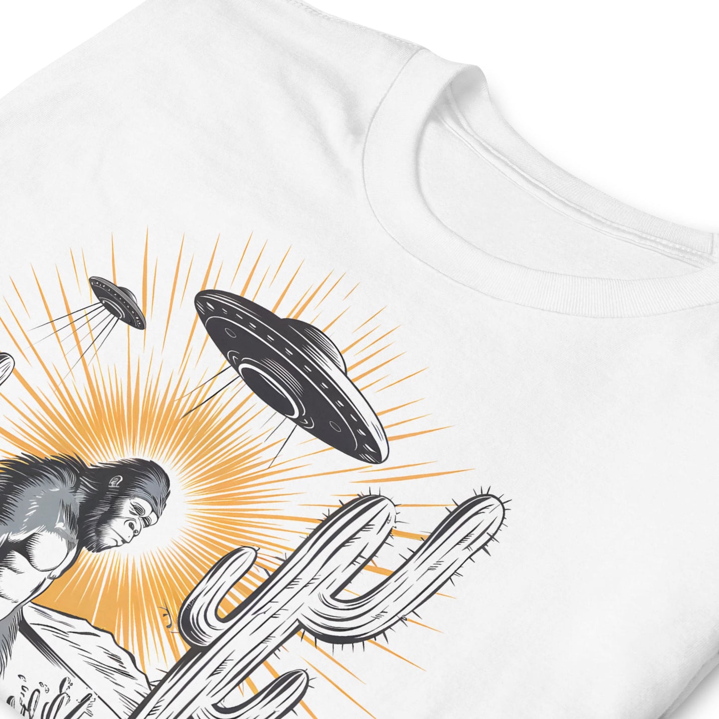 White t-shirt with a graphic design of a cactus, bigfoot, and UFOs on a white background