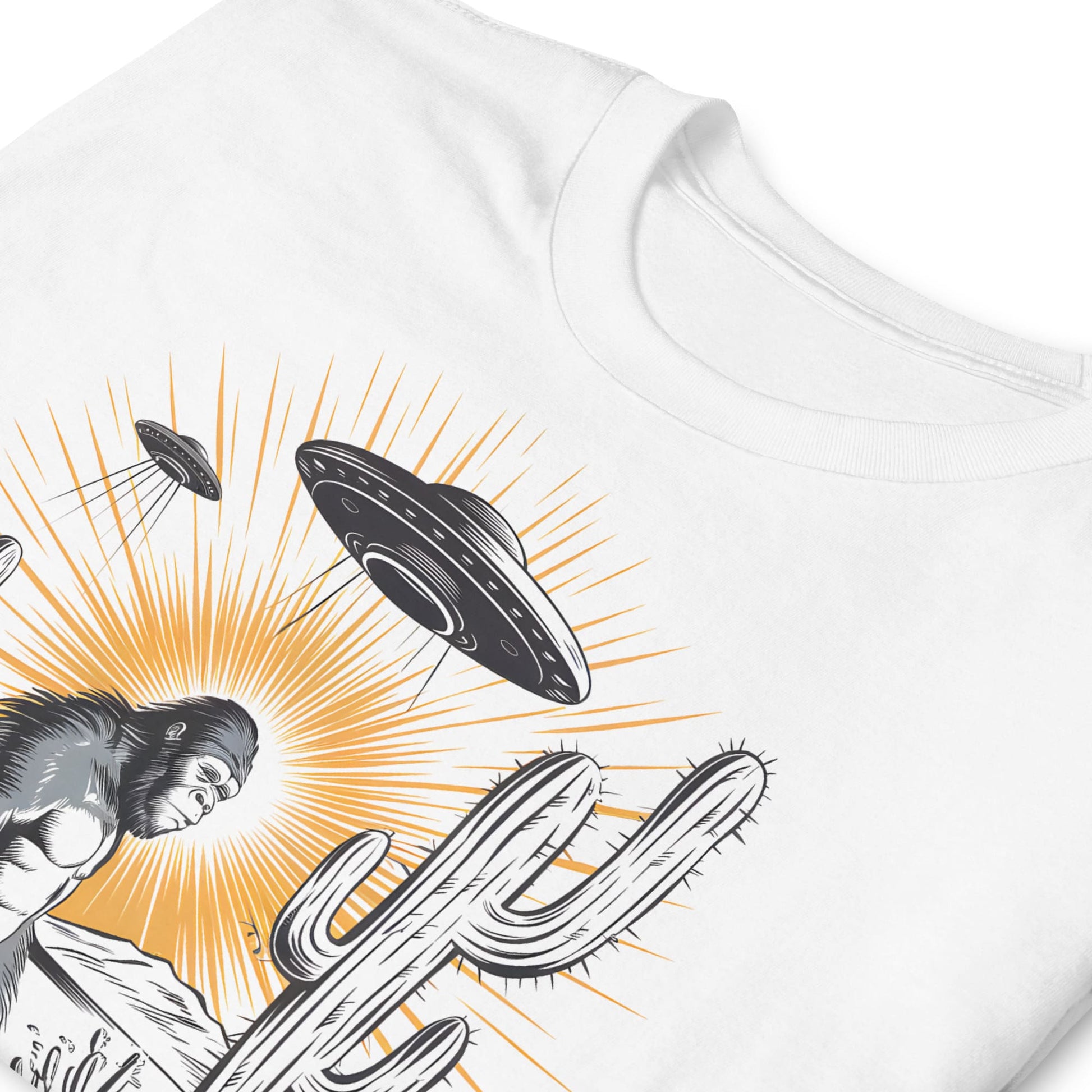 White t-shirt with a graphic design of a cactus, bigfoot, and UFOs on a white background