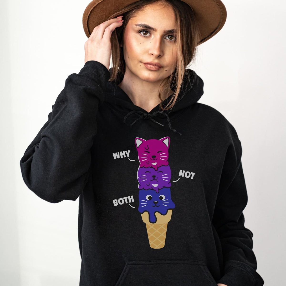 Person wearing a black kawaii bisexual  hoodie with colorful ice cream cone design and text.