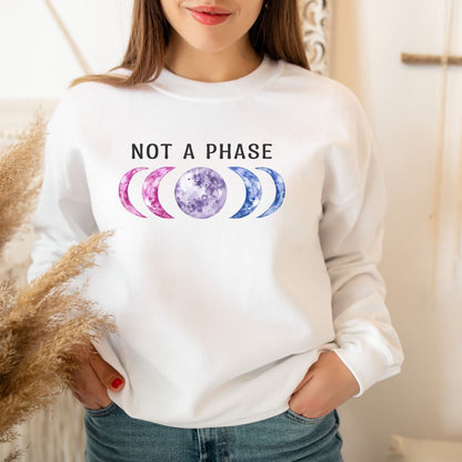 Person wearing a white bisexual sweatshirt with 'Not a Phase' and moon phase graphics.