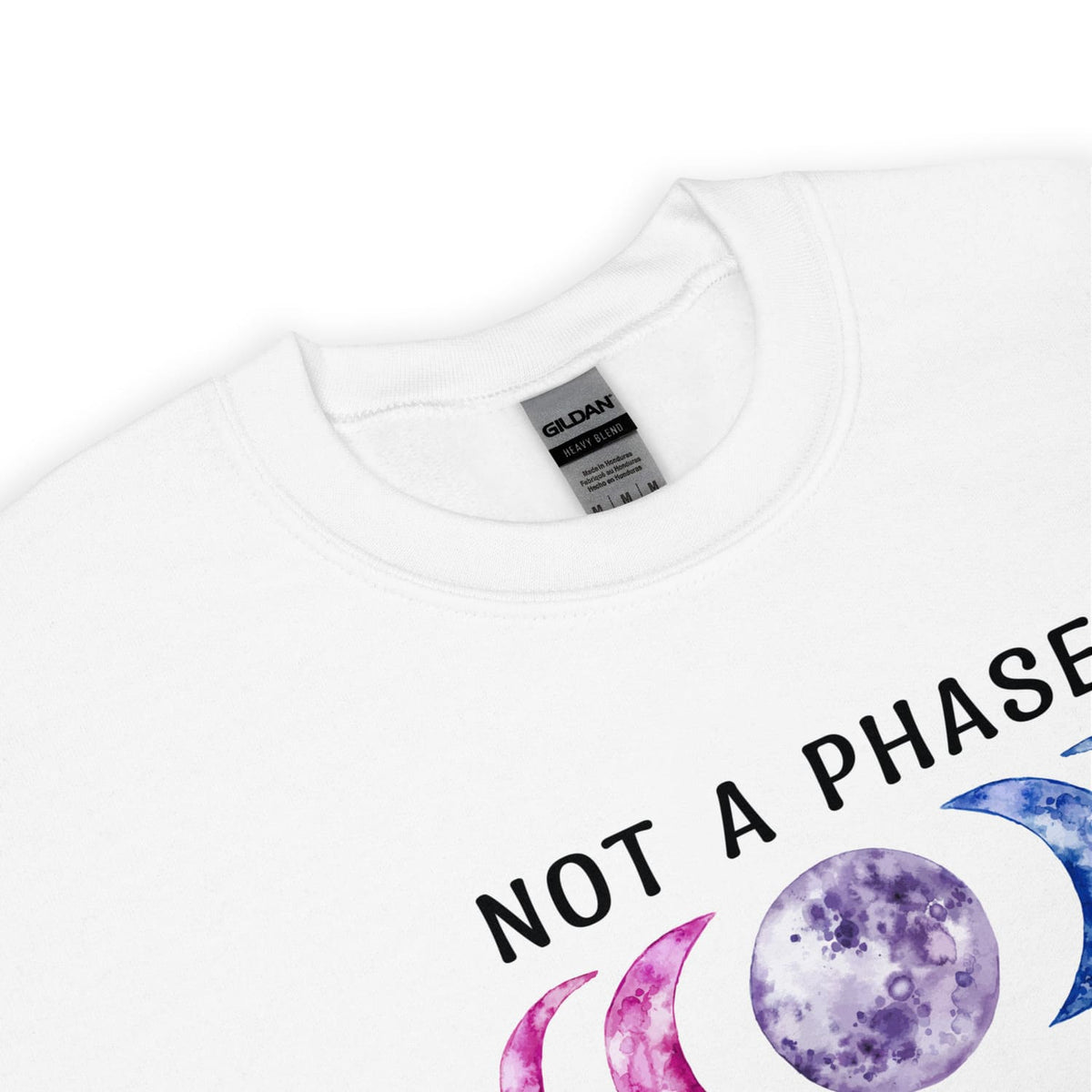 detail of bi pride sweatshirt with 'Not a Phase' text and moon graphic on a white background